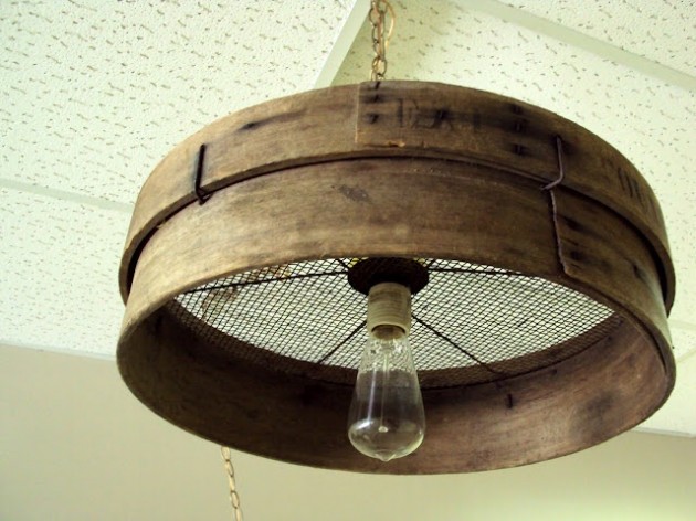 15. Old grain sieve repurposed into a primitive chandelier.
