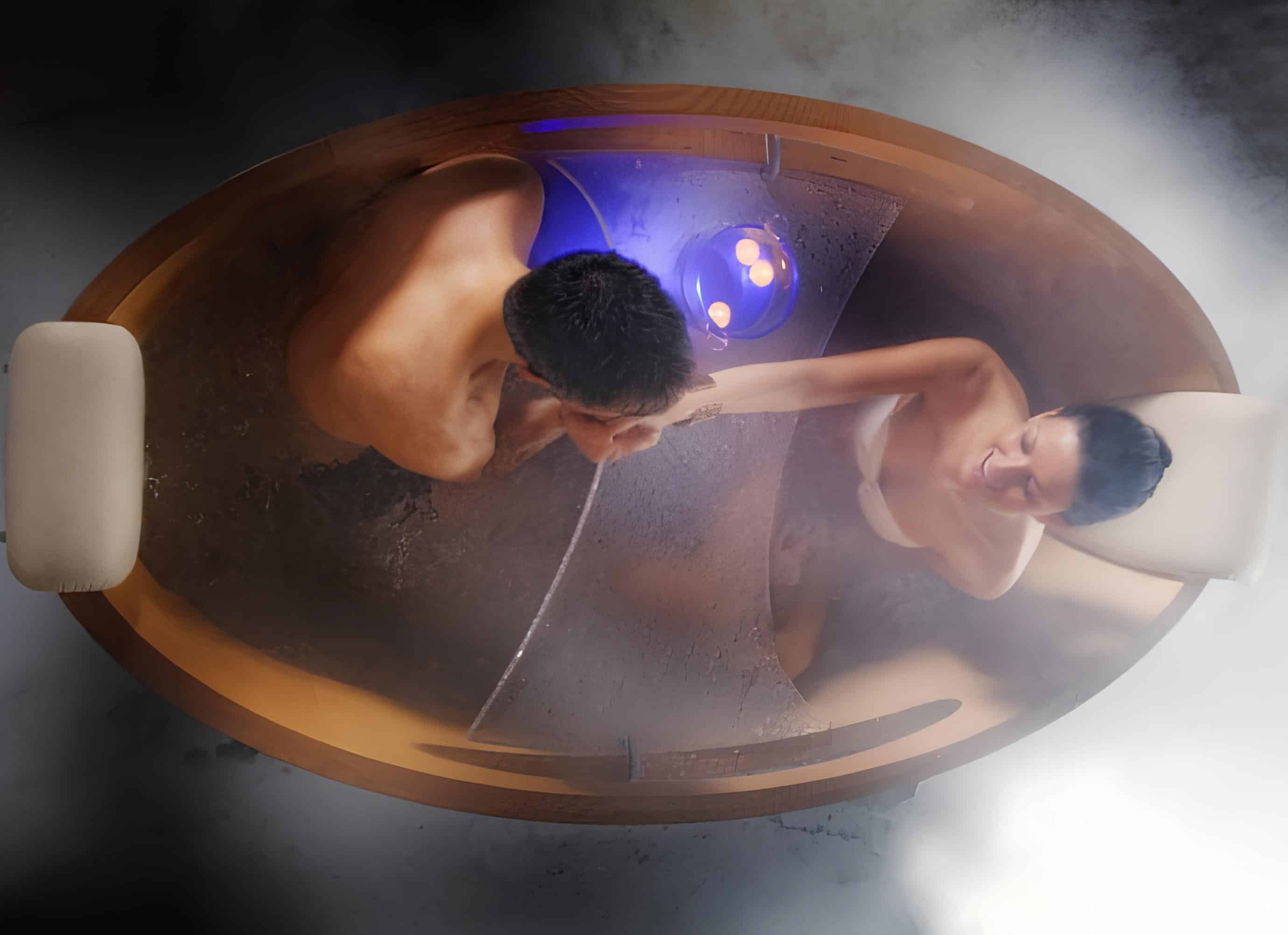 Romantic Couple Bath in Wooden Soaking Tub Romantic couple enjoying a steamy bath in a cozy wooden soaking tub