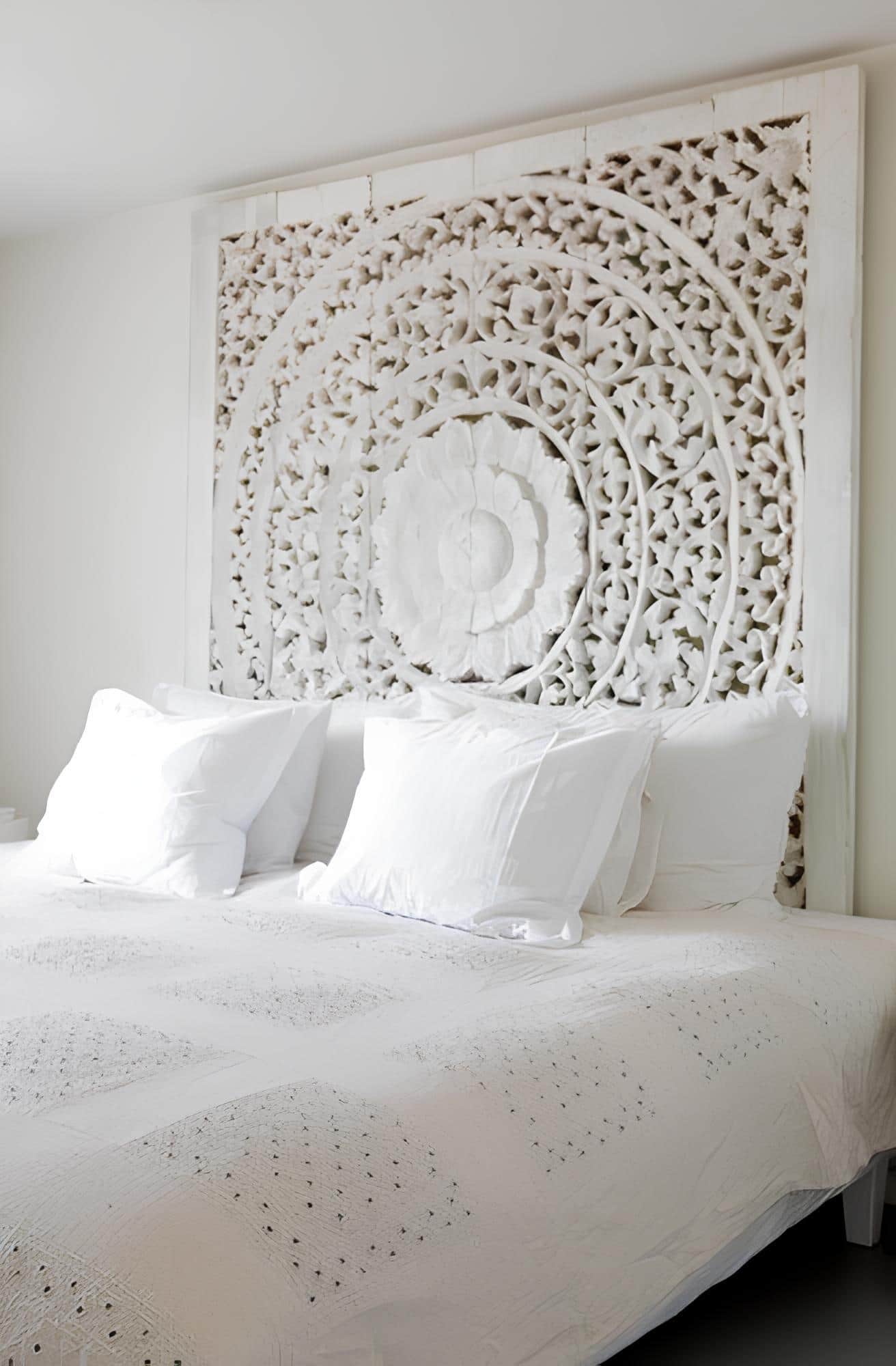 Elegant white carved wood headboard with intricate floral patterns