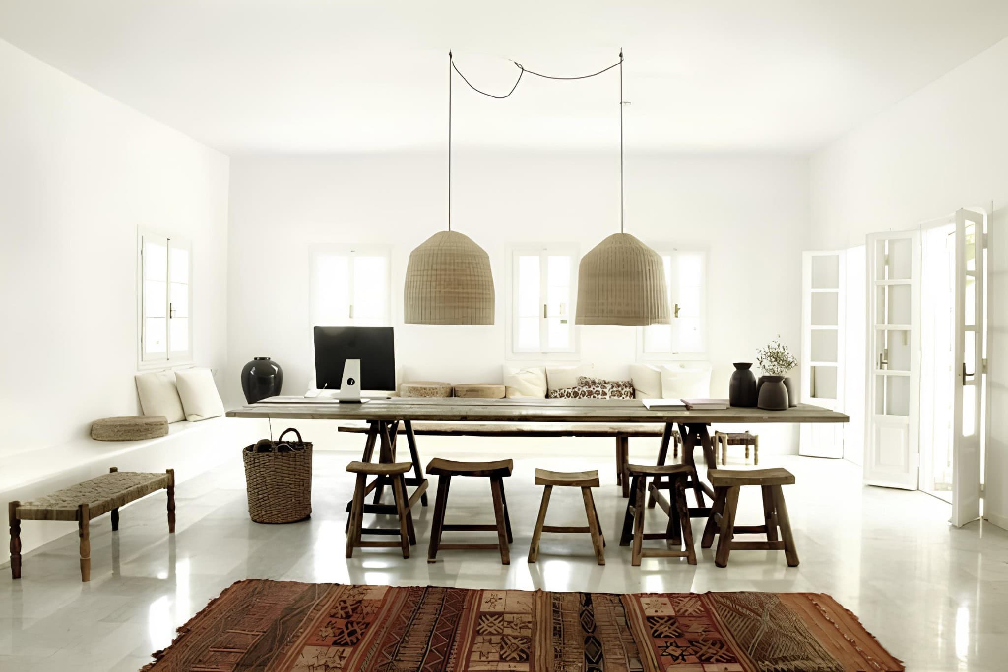 Boho Dining Room Natural Light Decor Open-plan dining room with natural light, woven pendant lights and rustic furniture.