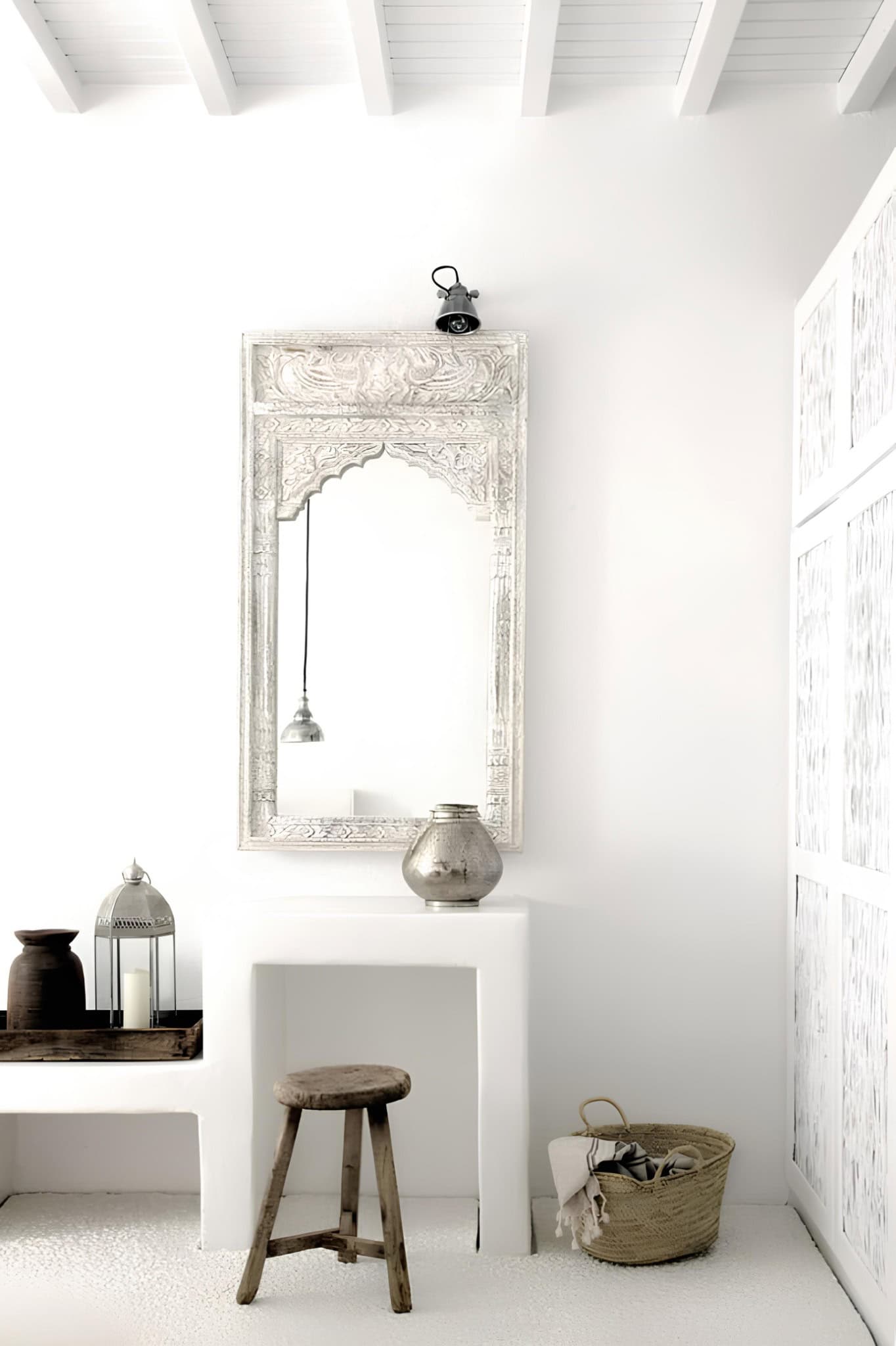 Boho Vanity Area Carved White Mirror Boho-inspired vanity with hand-carved white mirror and rustic stool.
