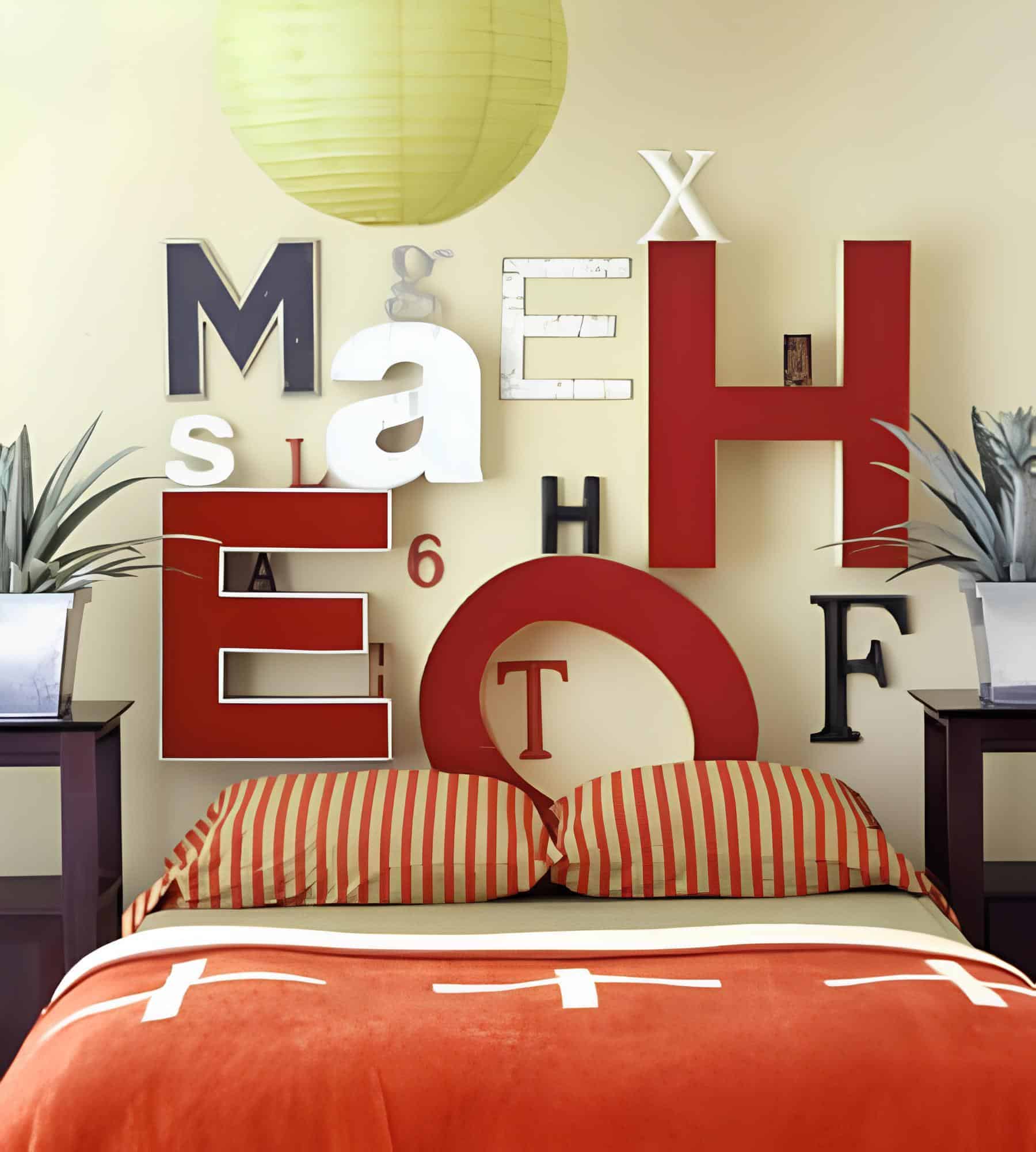 Creative headboard wall with oversized letters and striped bedding