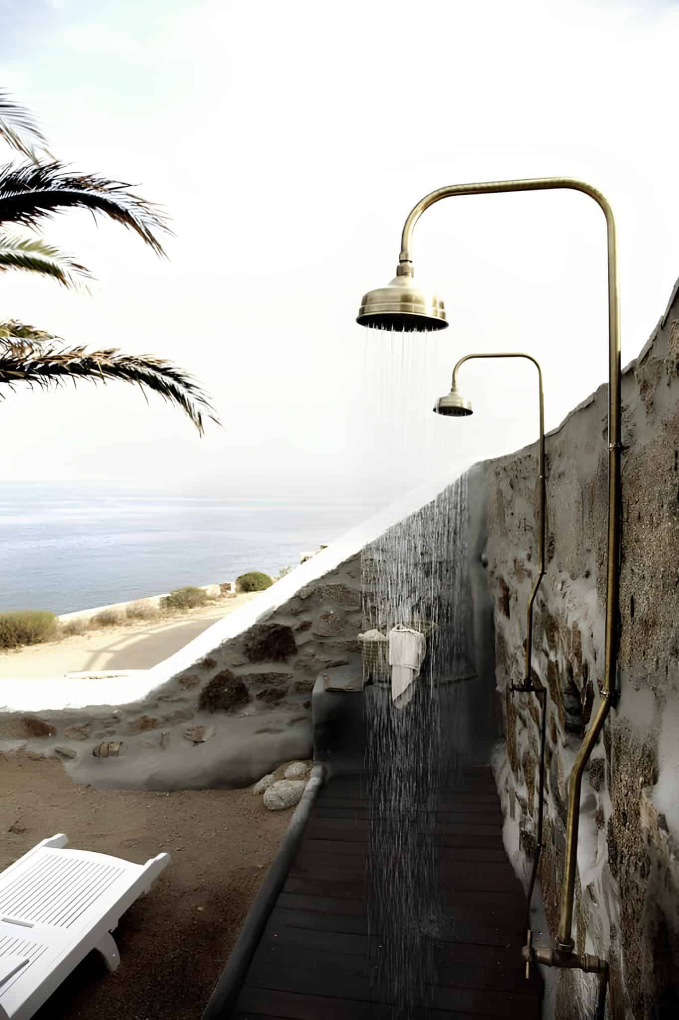 Brass Outdoor Shower Aegean Sea View Brass outdoor shower overlooking the Aegean Sea on a stone terrace.