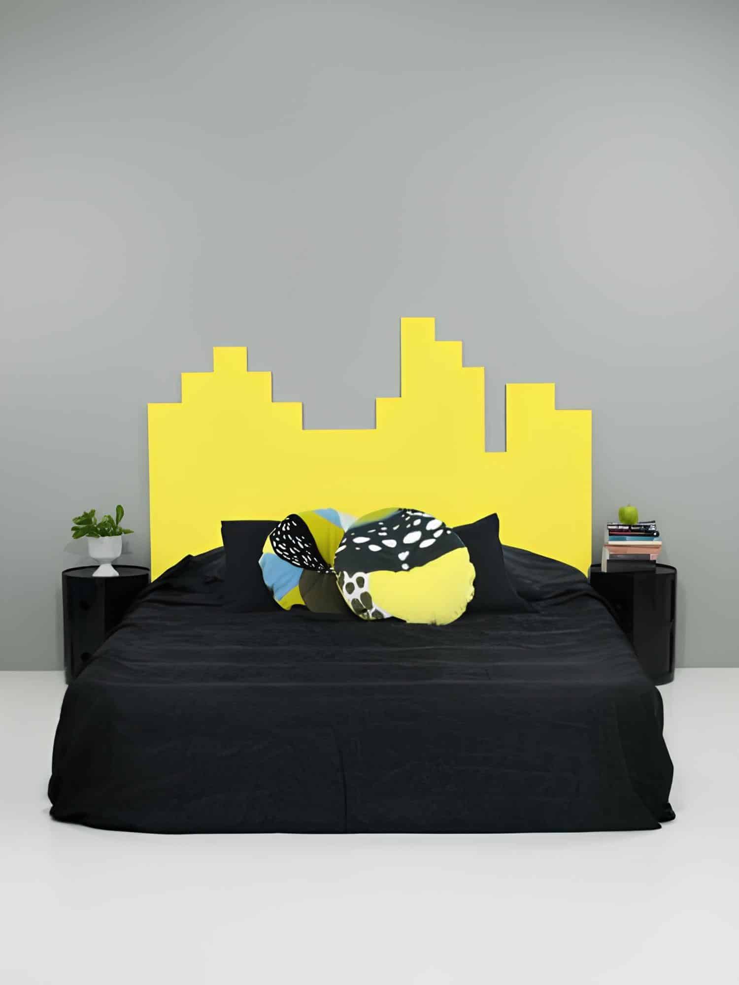 Bold bedroom design with a bright yellow skyline-shaped headboard