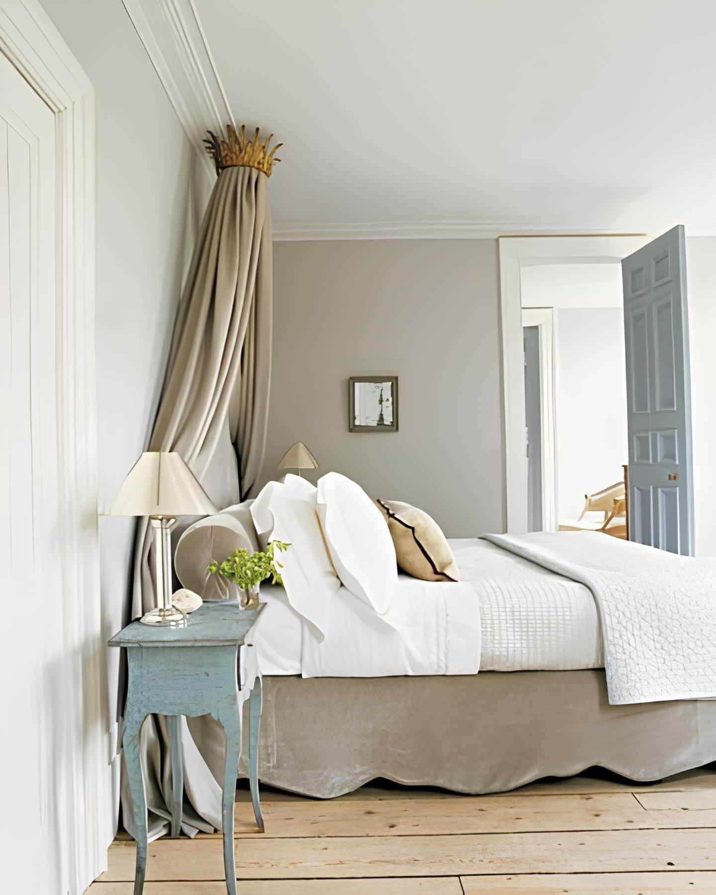 Elegant bedroom with crown-shaped canopy and neutral tones