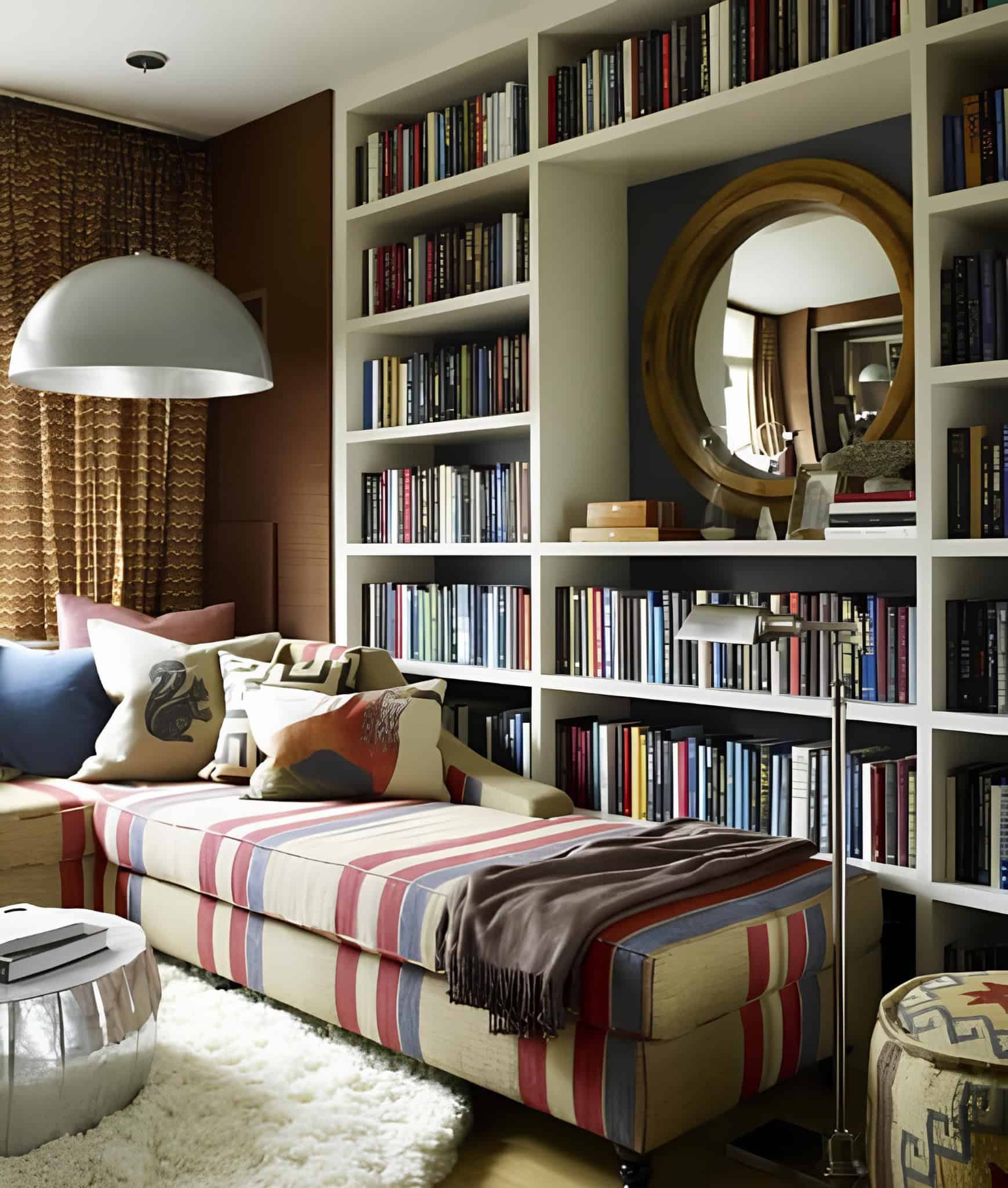Compact home library with built-in shelves and striped chaise lounge