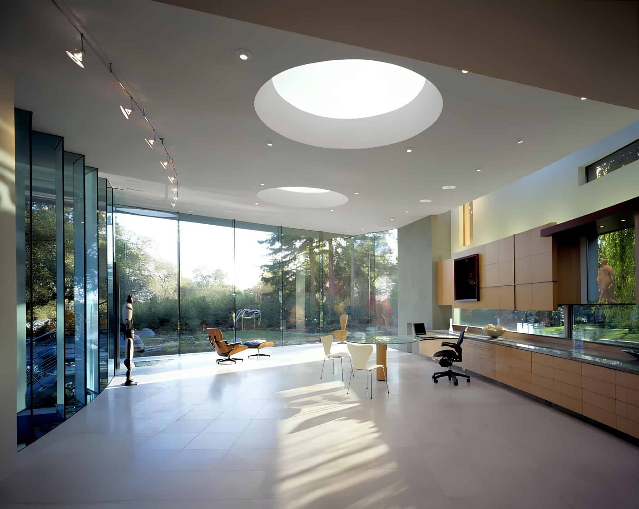 Elegant Modern Office Studio Design Wide interior of the studio featuring built-in cabinetry and sleek furniture under skylights.