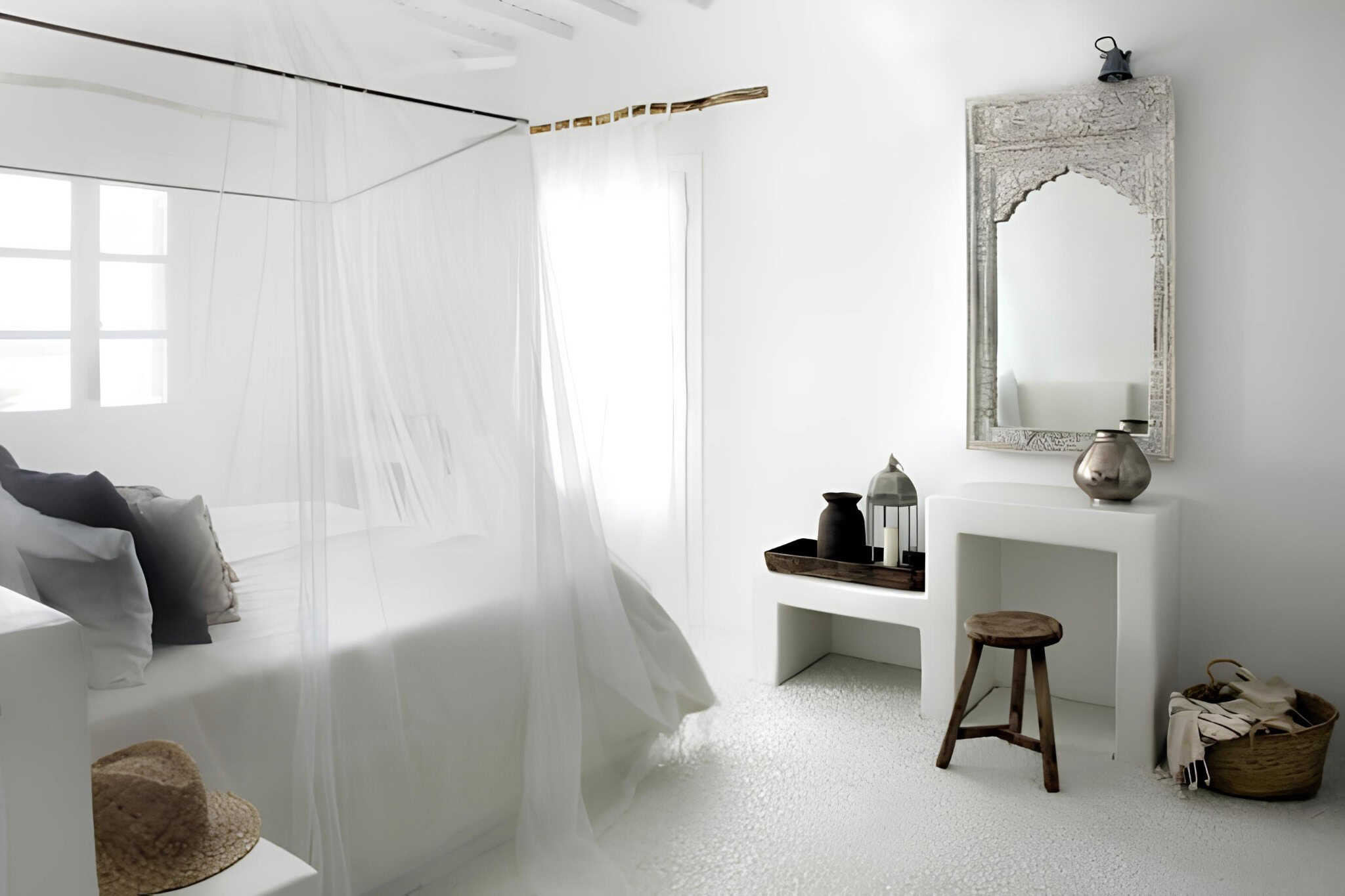 Ethnic Bedroom White Mirror and Stool Ethnic-inspired white bedroom corner with rustic mirror and wooden stool.