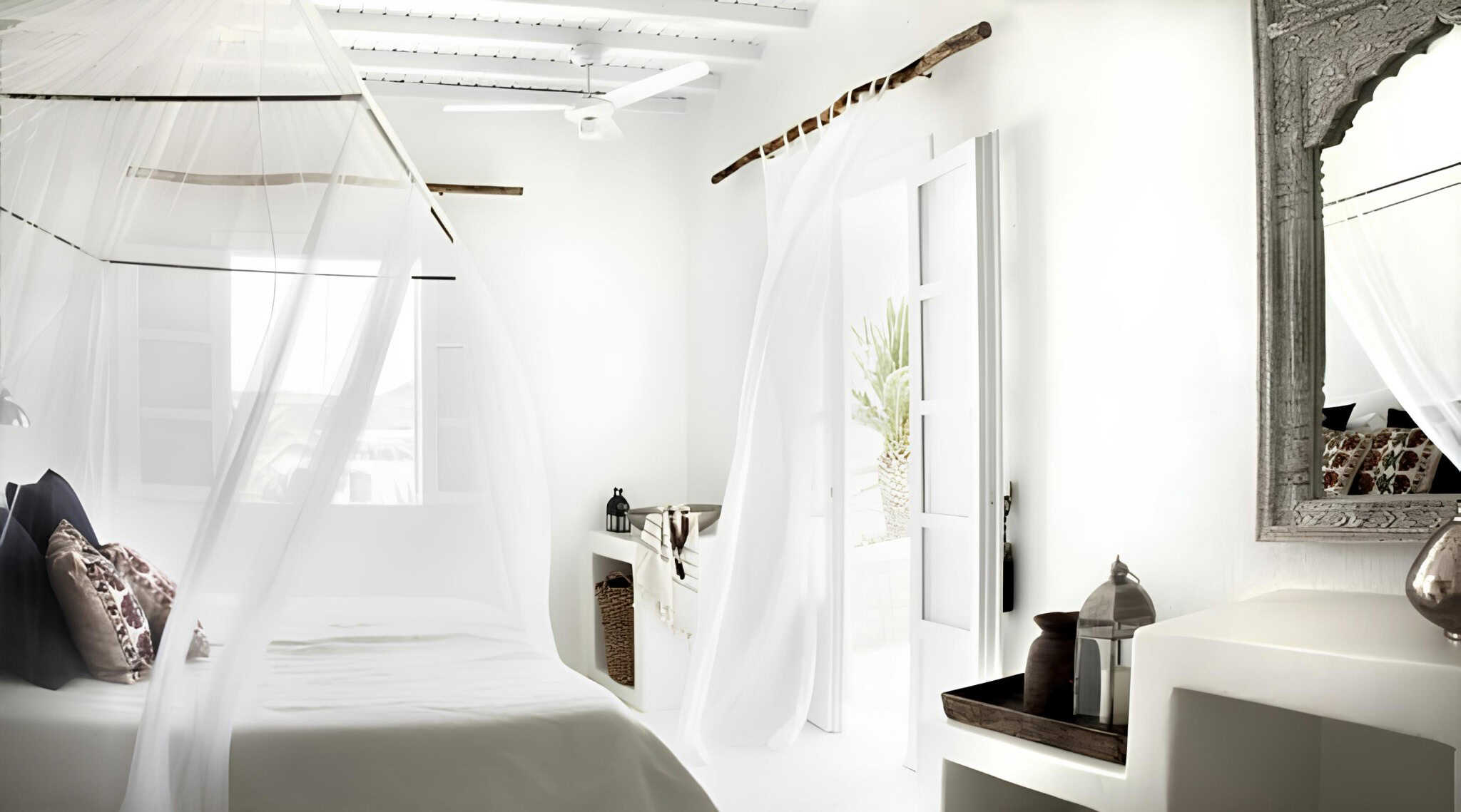 Flowing Curtains White Bedroom Interior White airy bedroom with flowing sheer curtains and canopy bed.