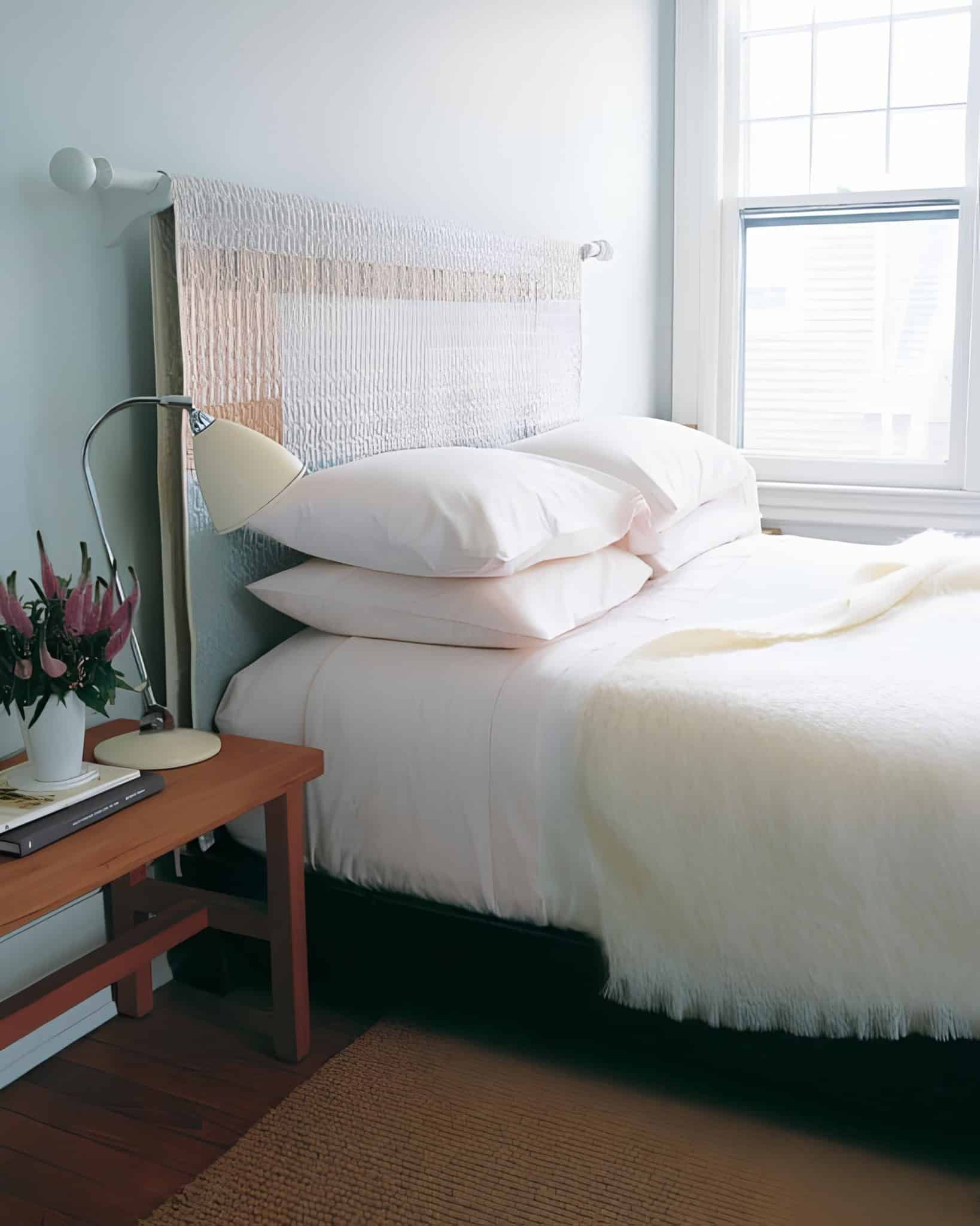 Simple and soft headboard design using quilted fabric for a minimalist bedroom