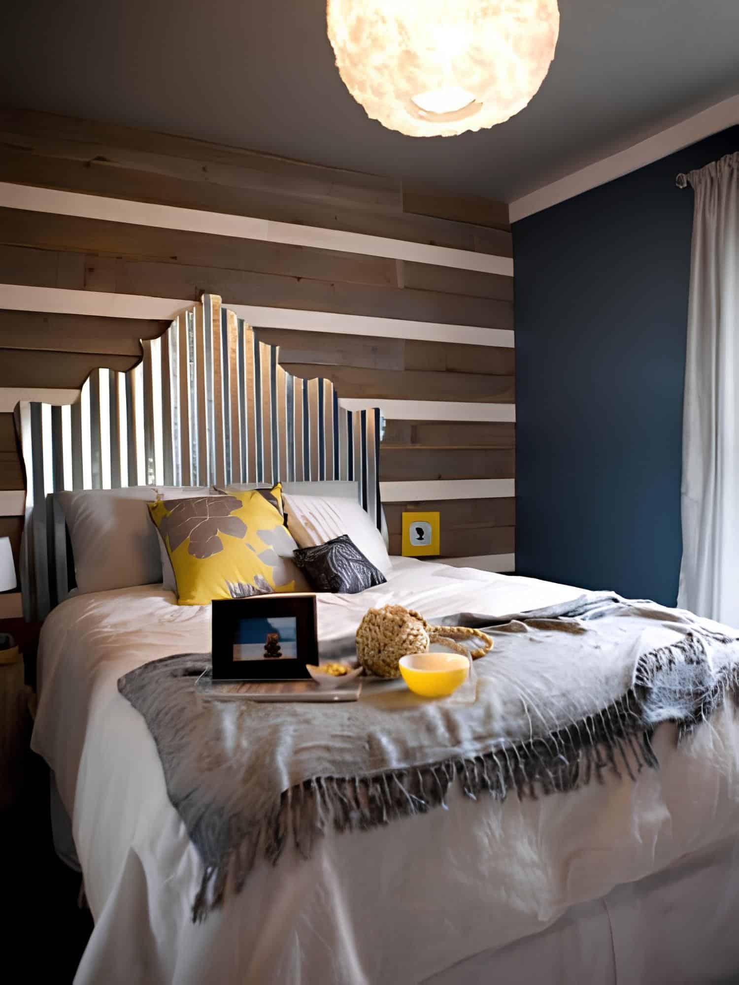 Contemporary bedroom featuring a striped wood accent wall and custom metallic headboard