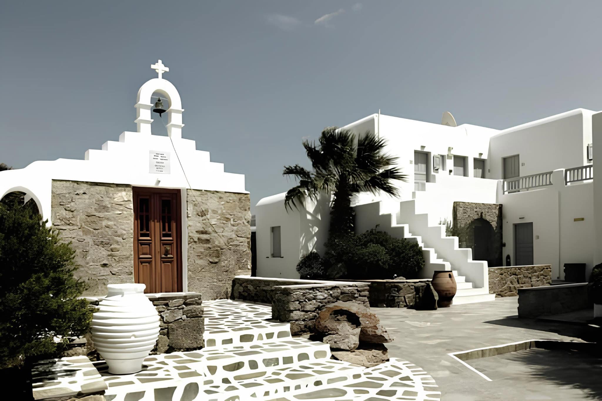 Mykonos Courtyard Chapel Staircase Traditional Mykonian courtyard with white chapel and stepped architecture.
