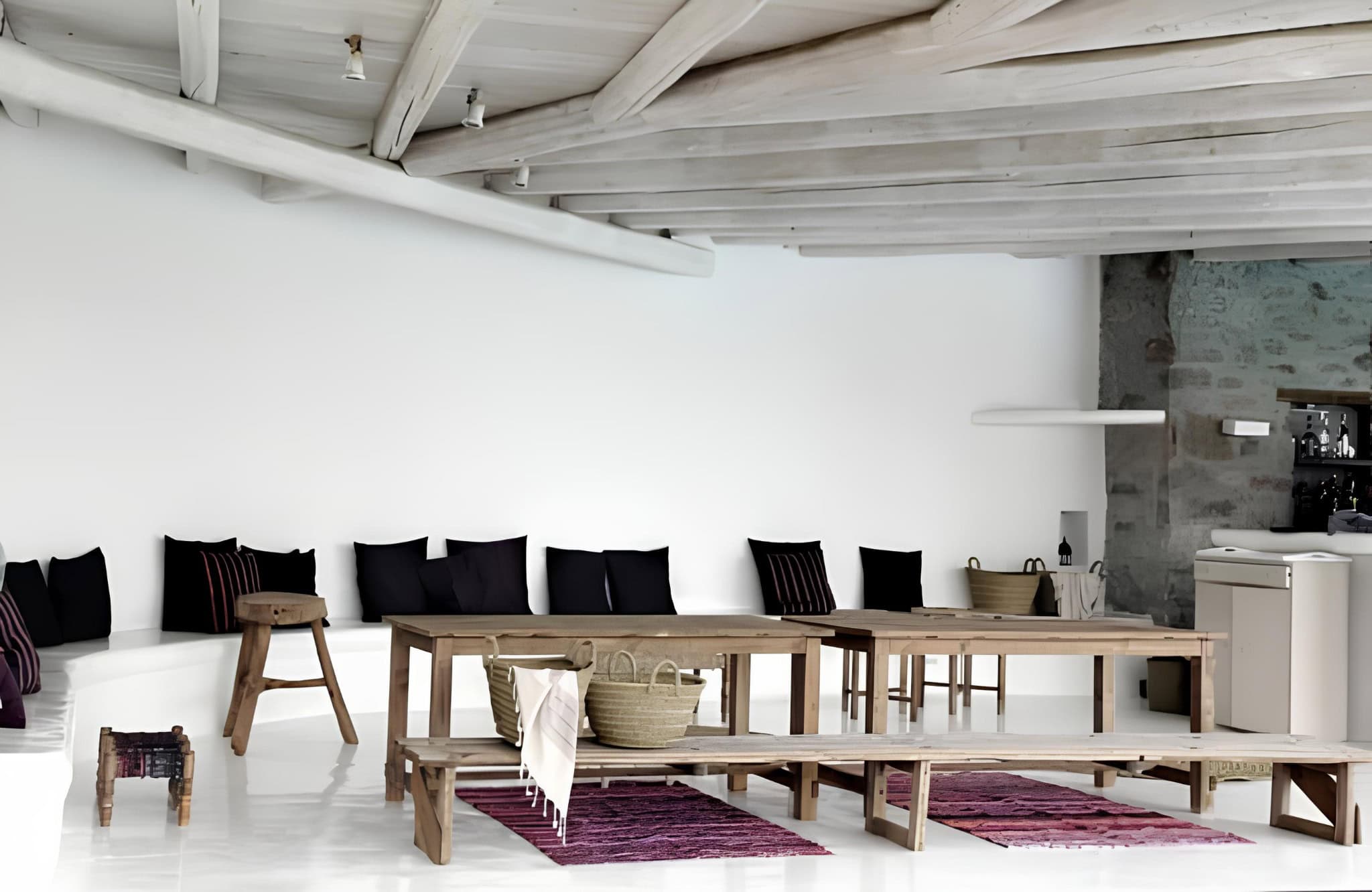 Rustic Dining Area Exposed Wooden Ceiling Rustic communal dining space with wooden benches and whitewashed beams.