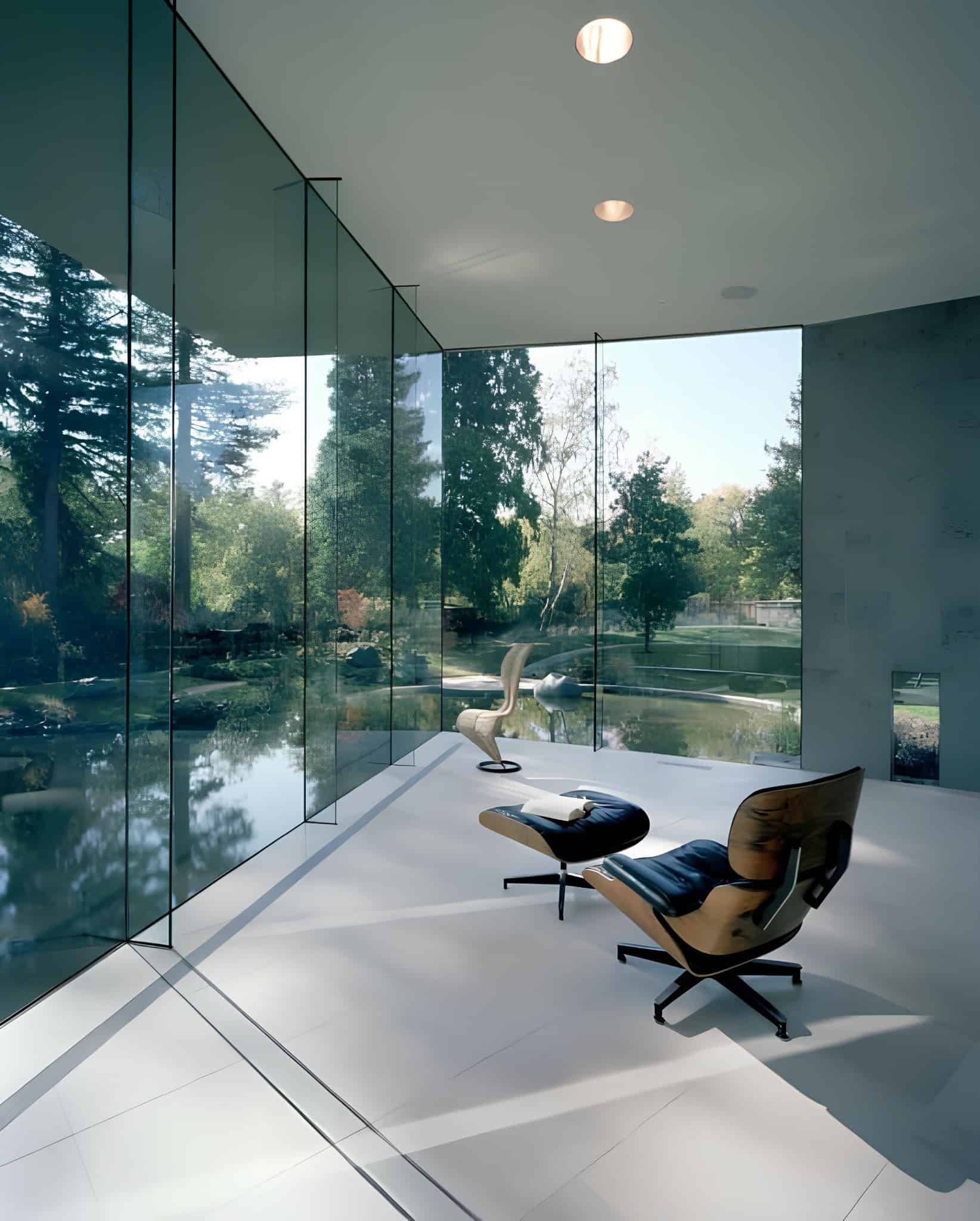 Serene Lounge Corner Lake View Minimalist lounge chair setup in glass-walled corner with tranquil lake view.