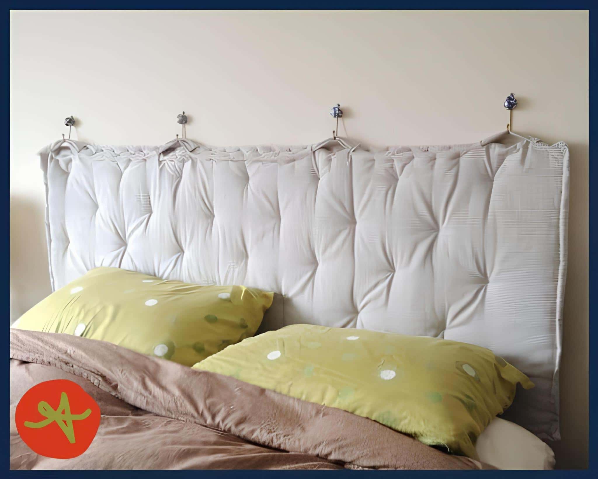 Tufted headboard panel suspended from decorative hooks