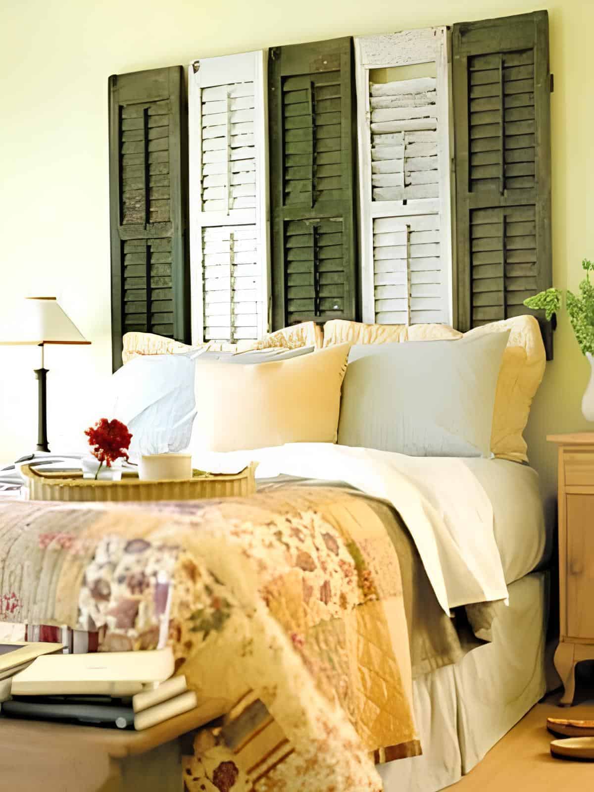 Rustic bedroom featuring a headboard made from repurposed vintage shutters