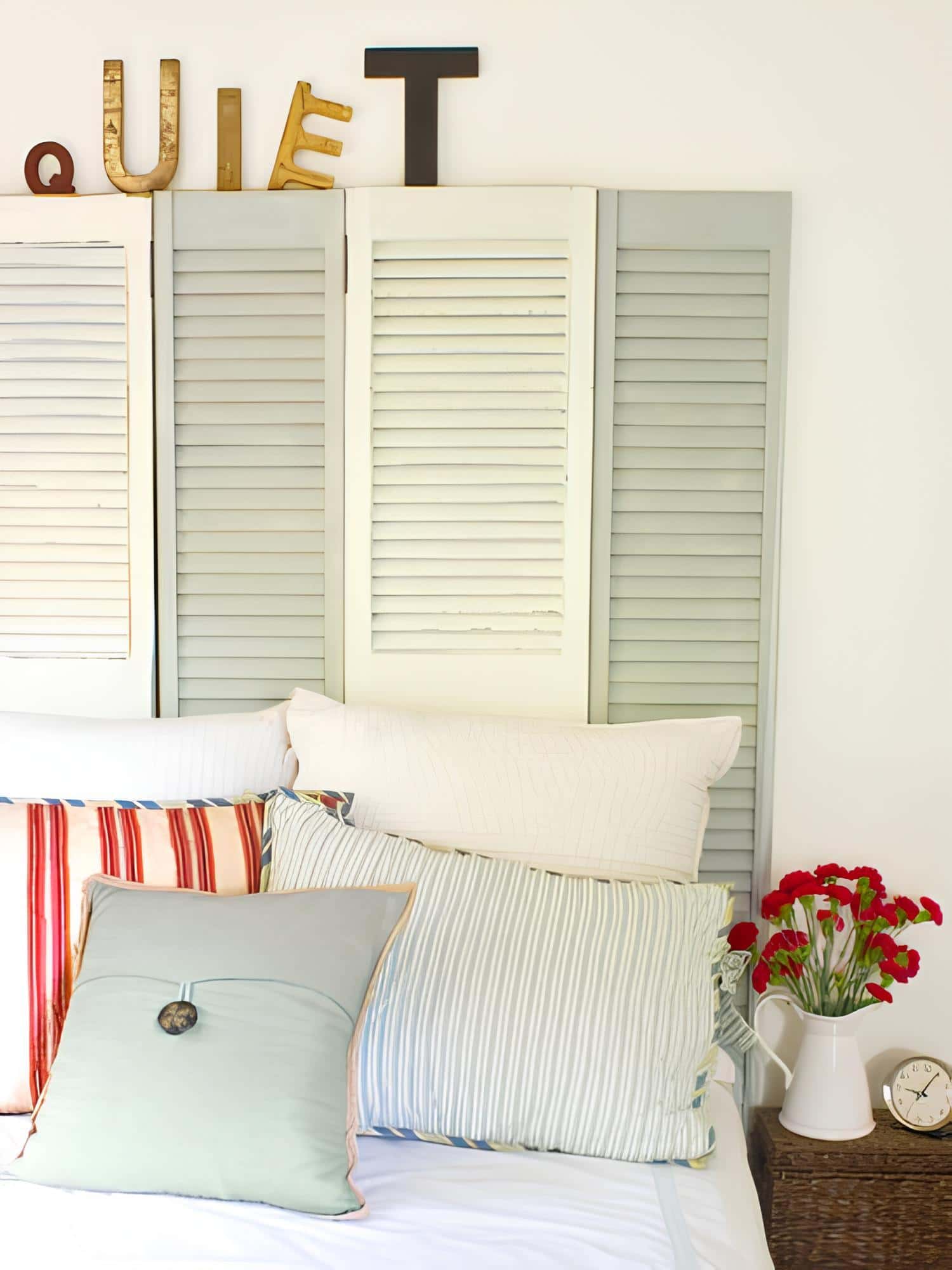 Upcycled vintage shutters repurposed as a unique headboard