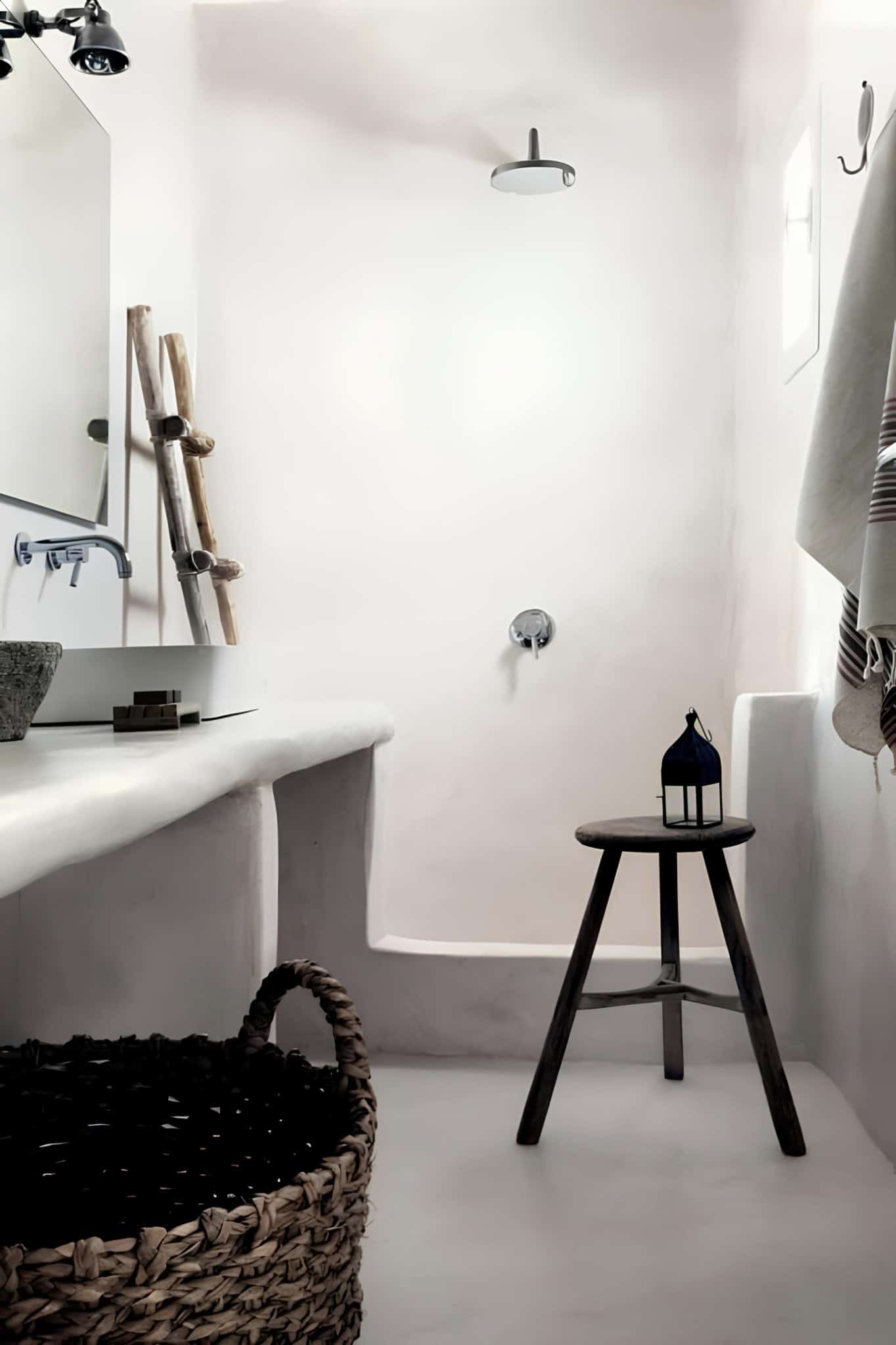 White Bathroom Stool Lantern and Shower Minimalist white bathroom with stool, lantern, and walk-in shower.