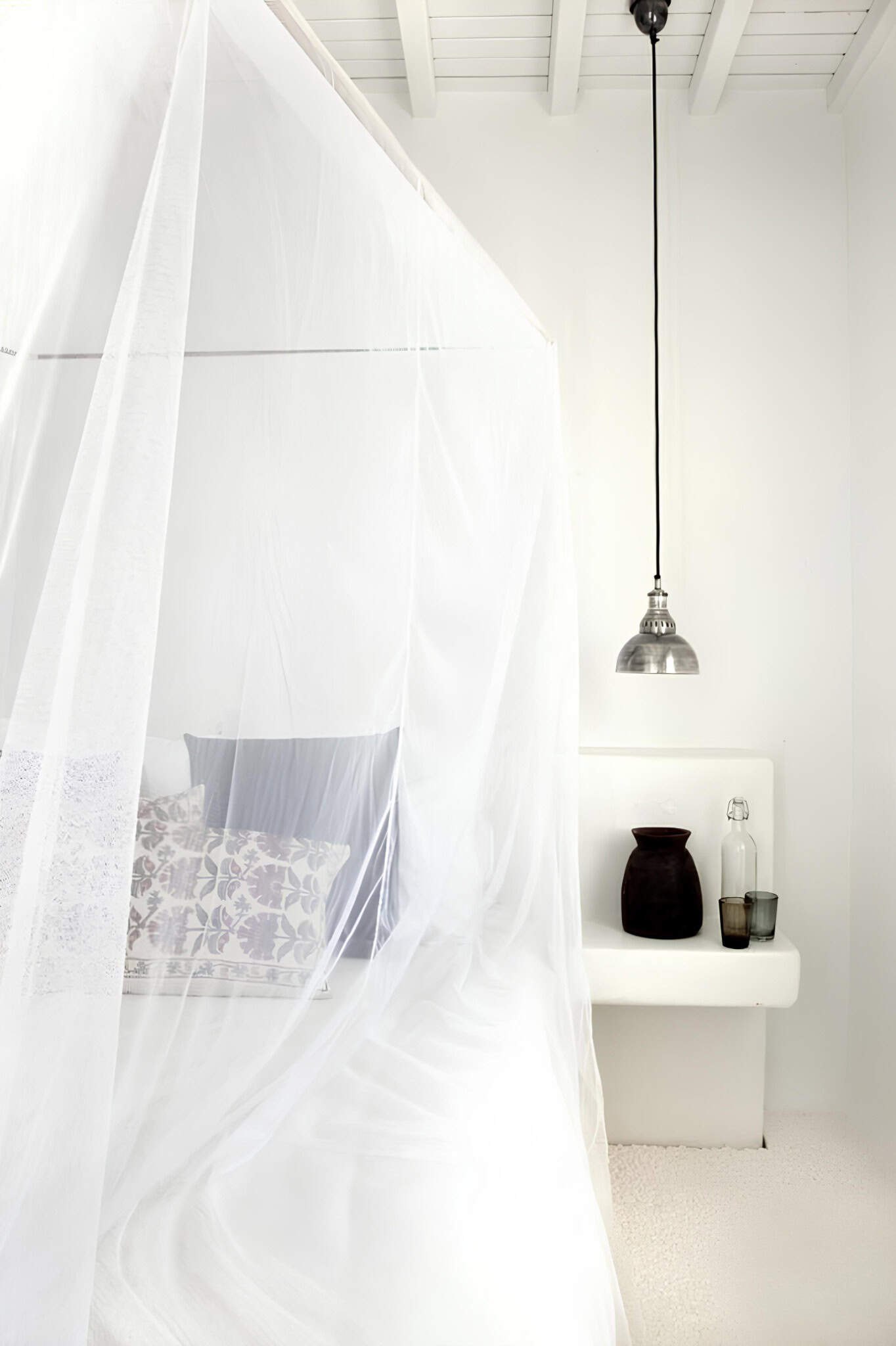 White Canopy Bed Industrial Lamp Elegant canopy bed with sheer drapes and industrial pendant lighting.