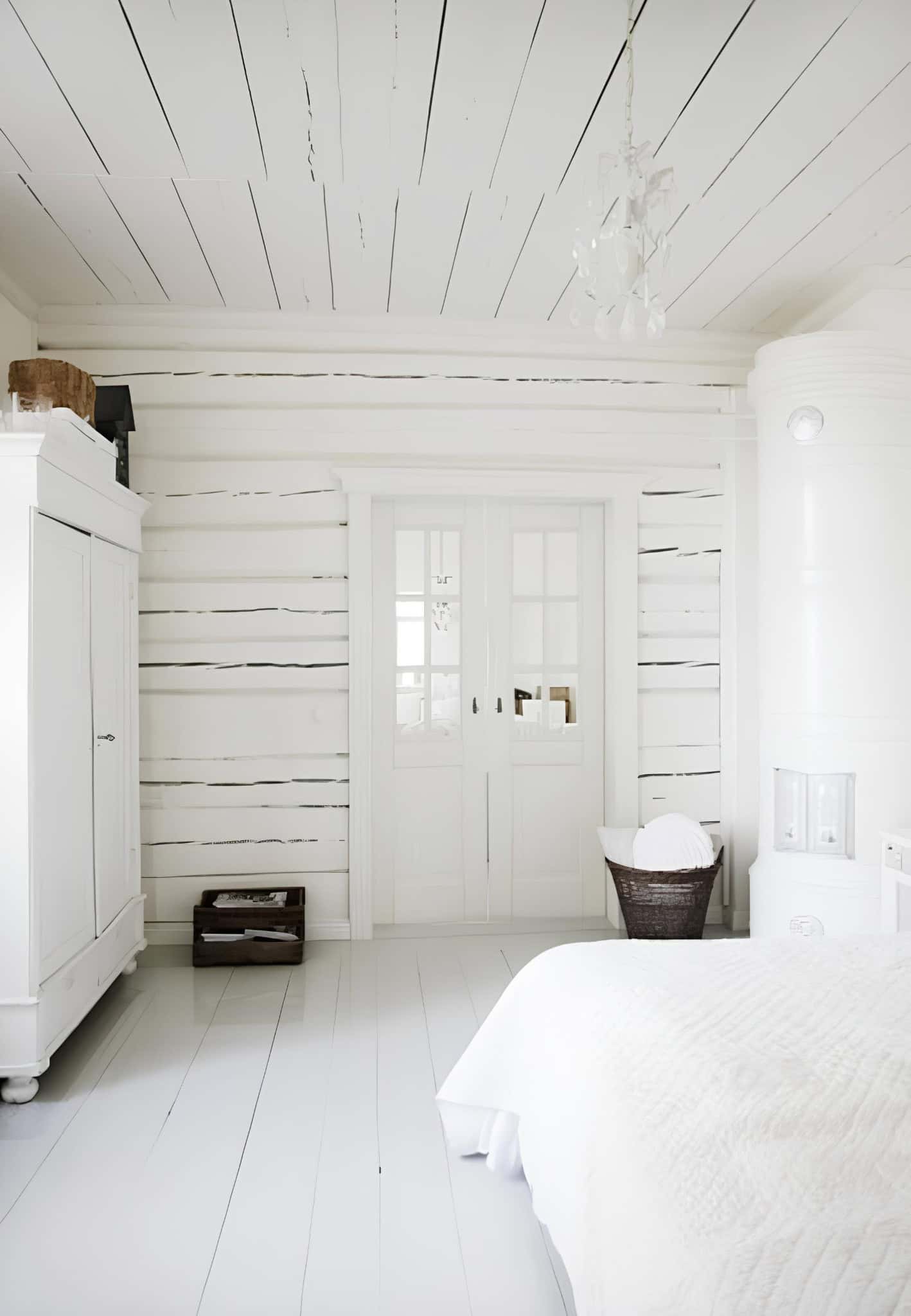 All White Log Cabin Bedroom with Double Doors Whitewashed log cabin bedroom with paneled ceiling and closet doors