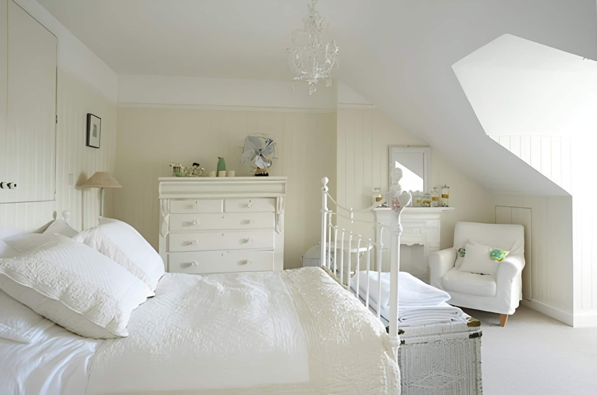 Attic White Bedroom with Vintage Charm Cozy attic bedroom with white vintage furniture and chandelier