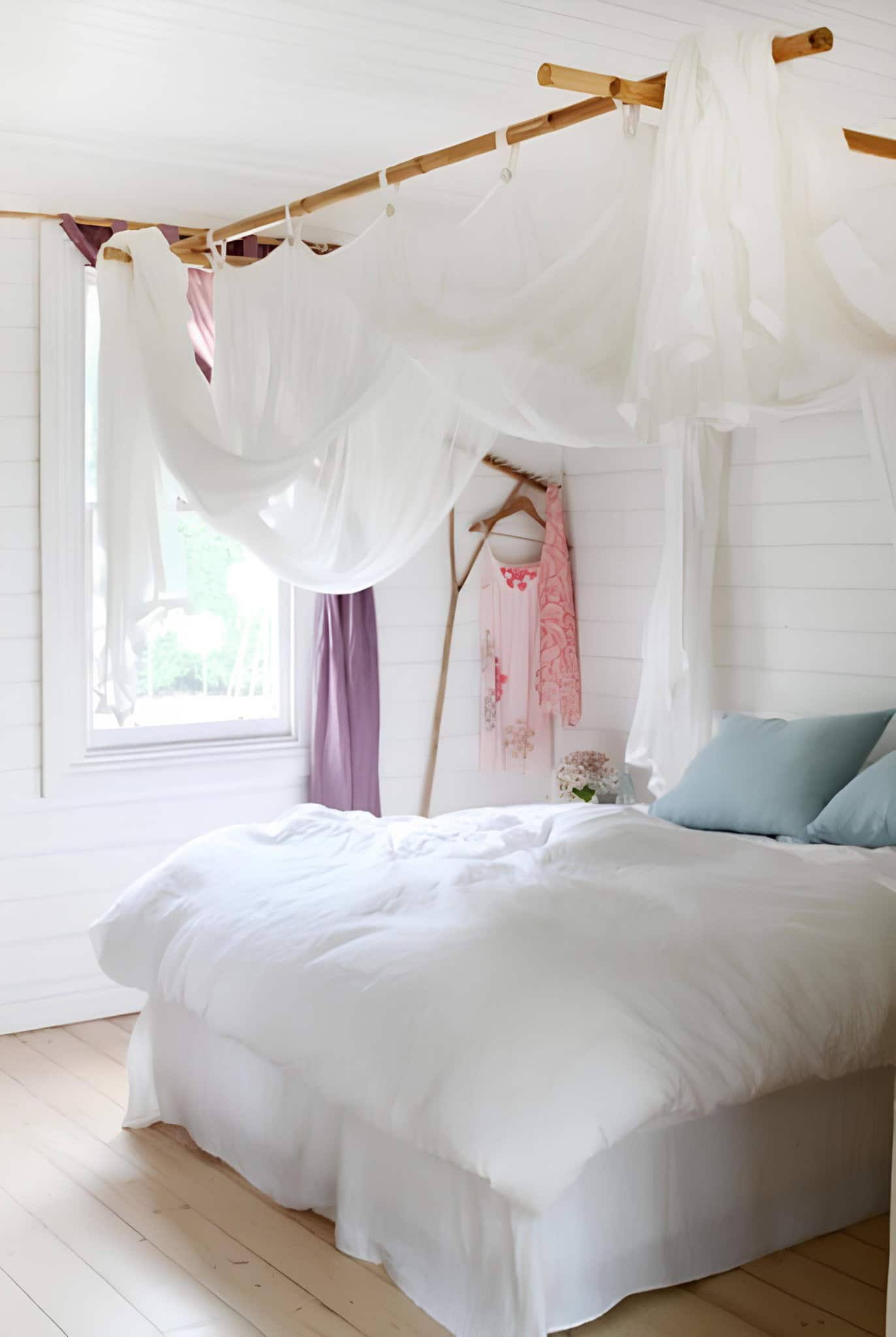 Boho Bedroom with Sheer Drapes and Wood Frame Bohemian white bedroom with airy drapes hung from natural wood poles