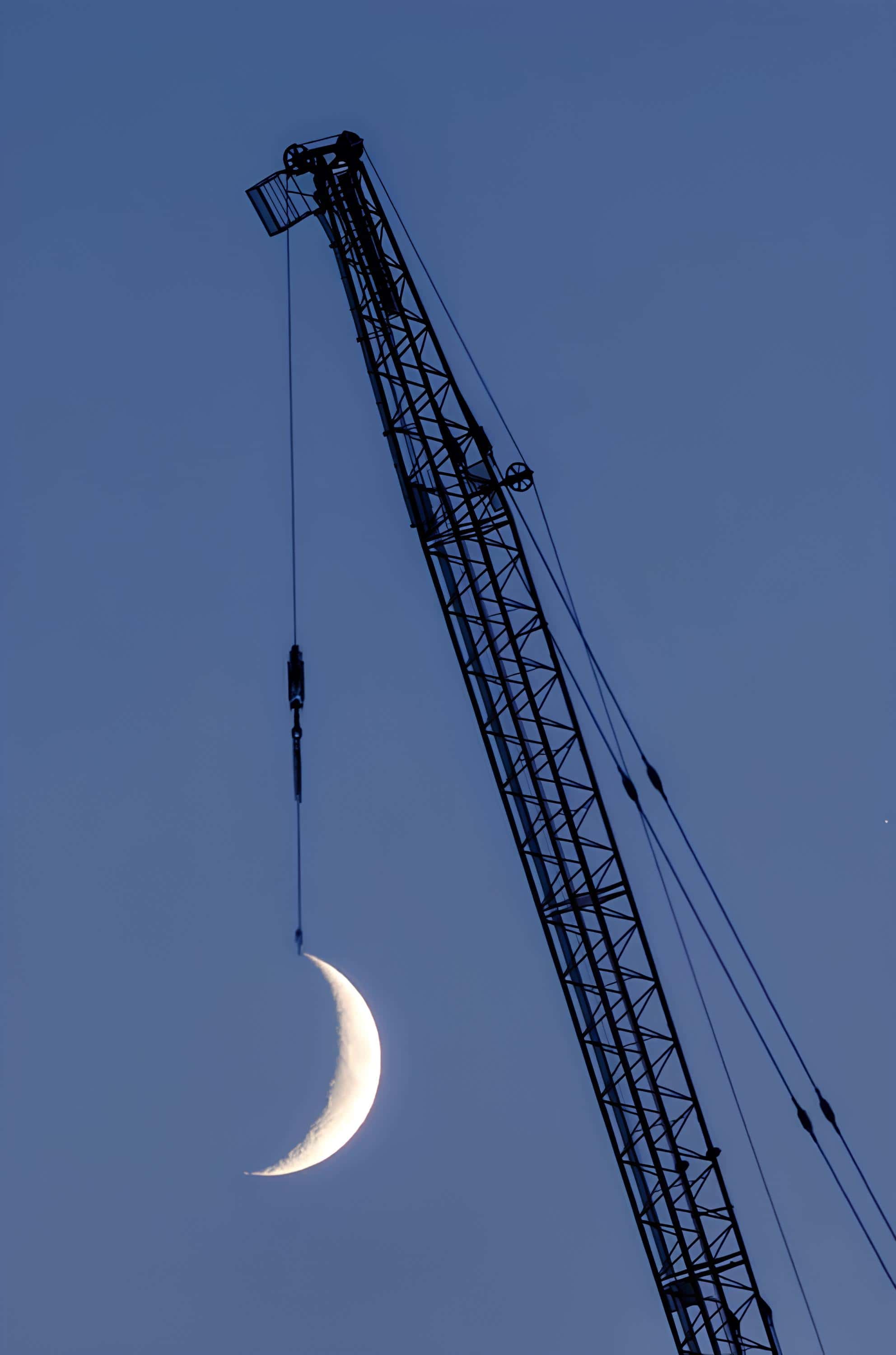 Crescent Moon Lifted by Crane Crescent moon appearing to be lifted by crane hook