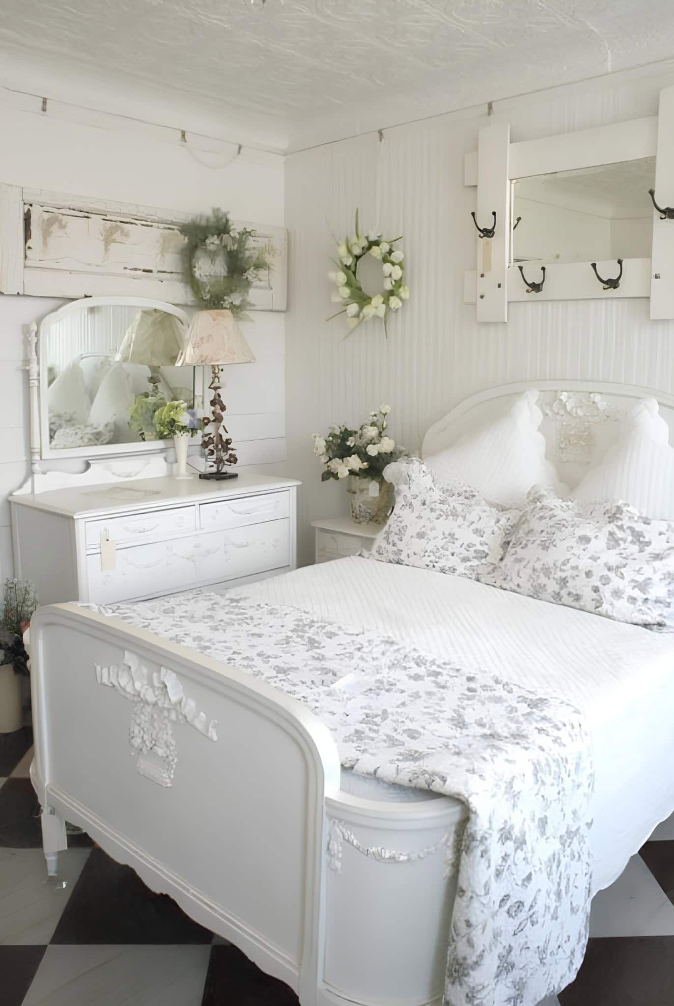 French Country Bedroom with Floral Bedding Charming French country bedroom with floral white and gray bedding and antique furniture