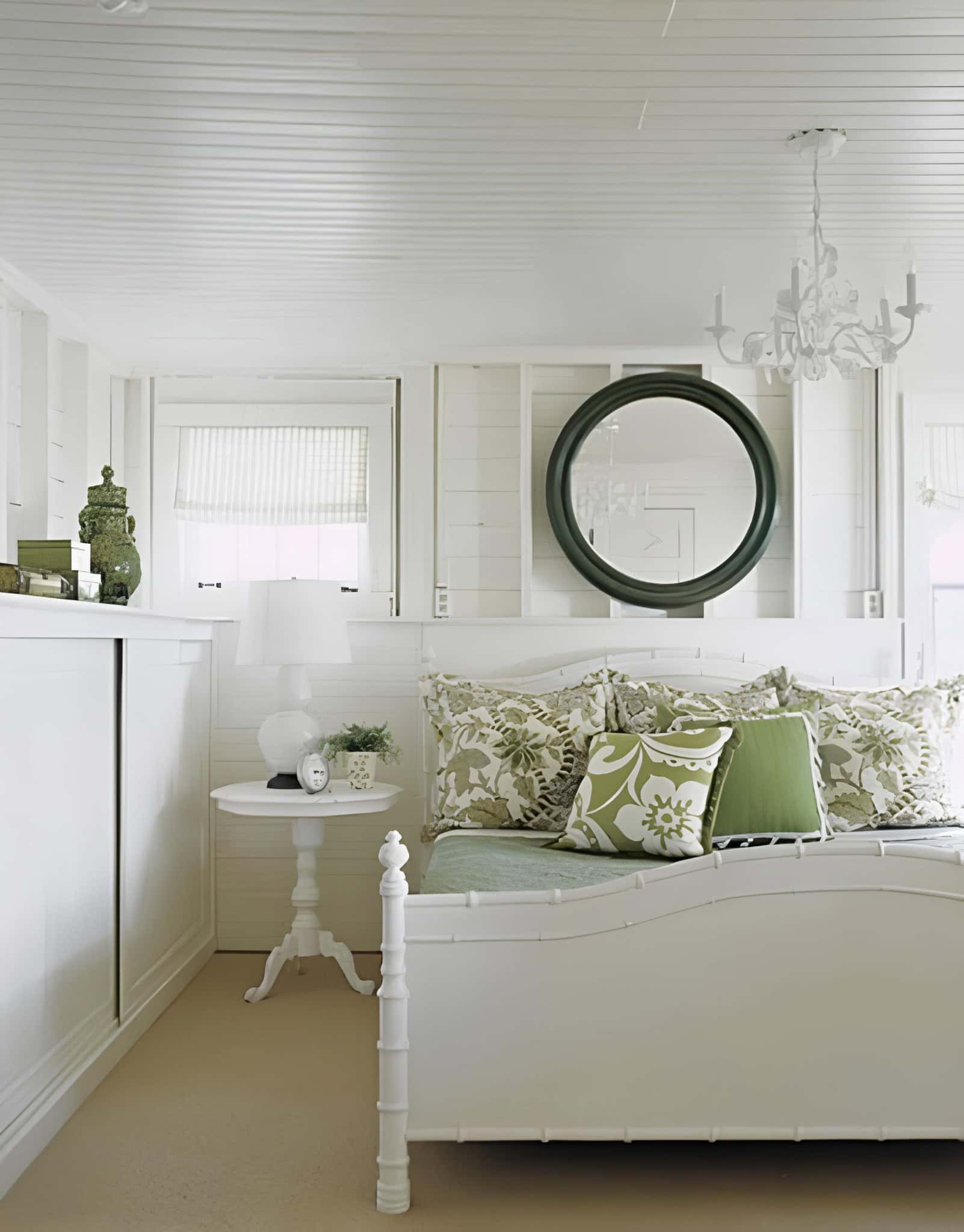 Green Accented White Bedroom with Floral Pillows White room with green floral pillows and round mirror