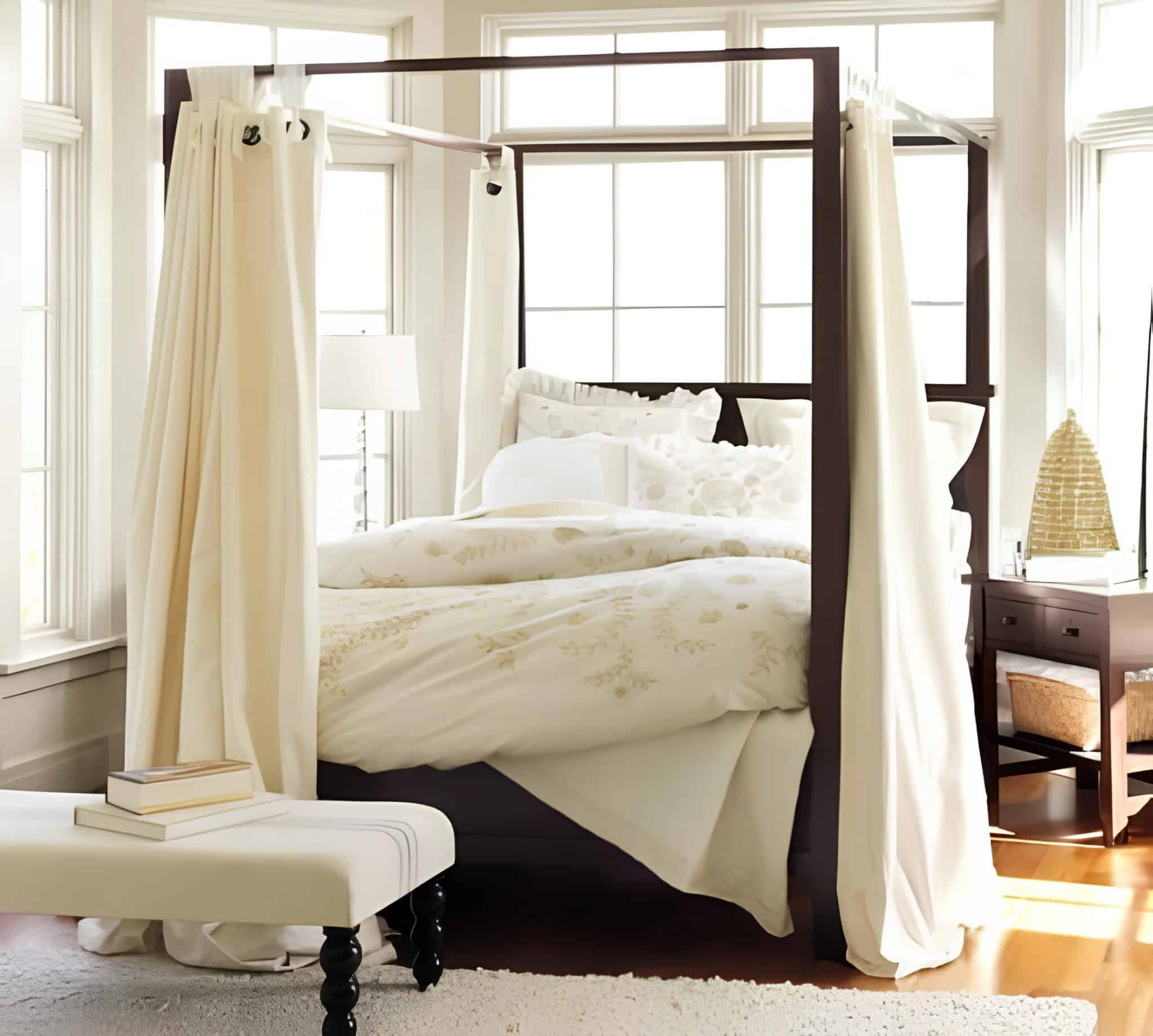 Luxury Canopy Bedroom with Dark Frame Elegant canopy bed with dark wood frame and ivory curtains