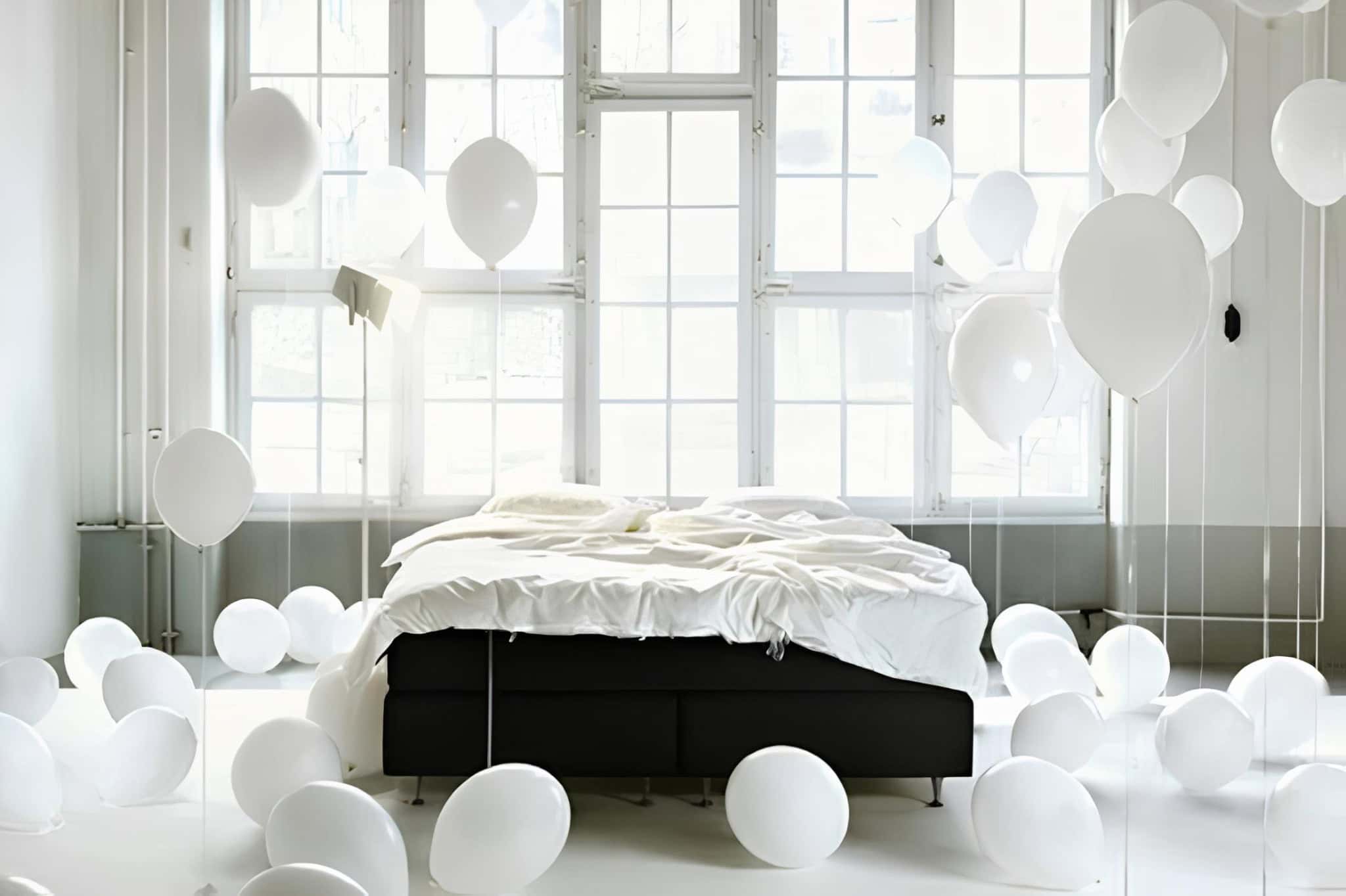 Modern Bedroom with White Balloons and Black Bed Contemporary bedroom with black platform bed surrounded by white balloons