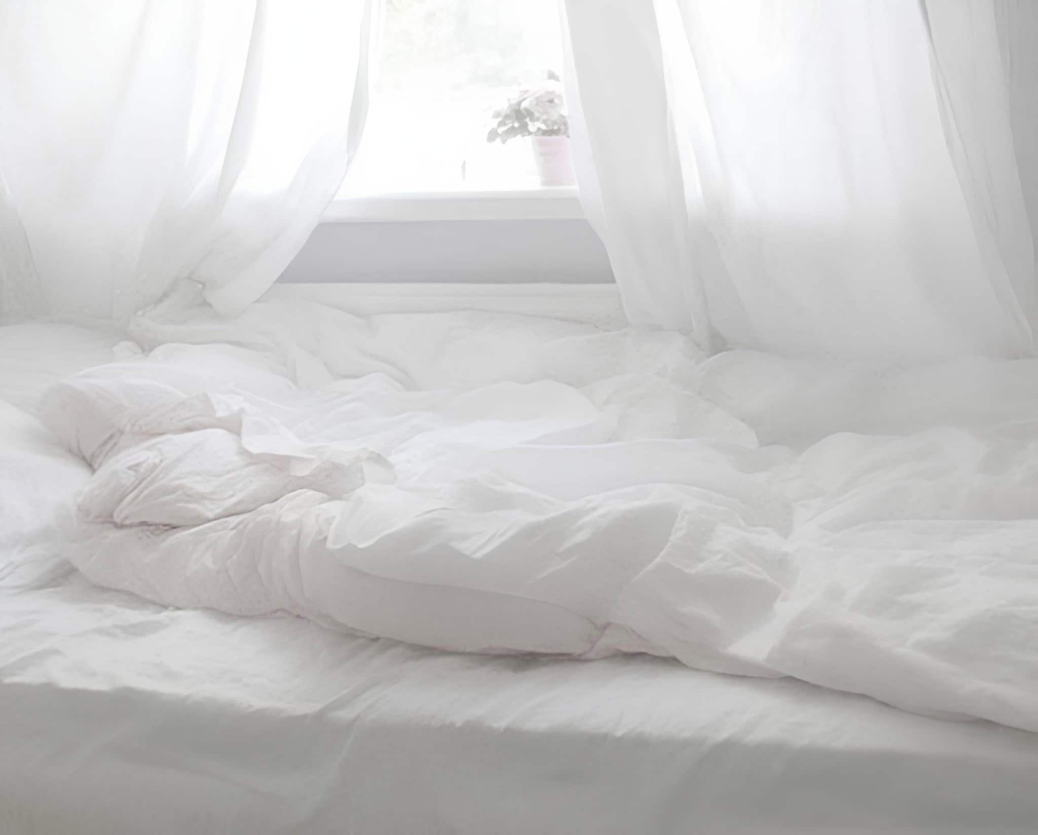 Soft White Bed with Flowing Curtains White bedding with relaxed drapery and window light