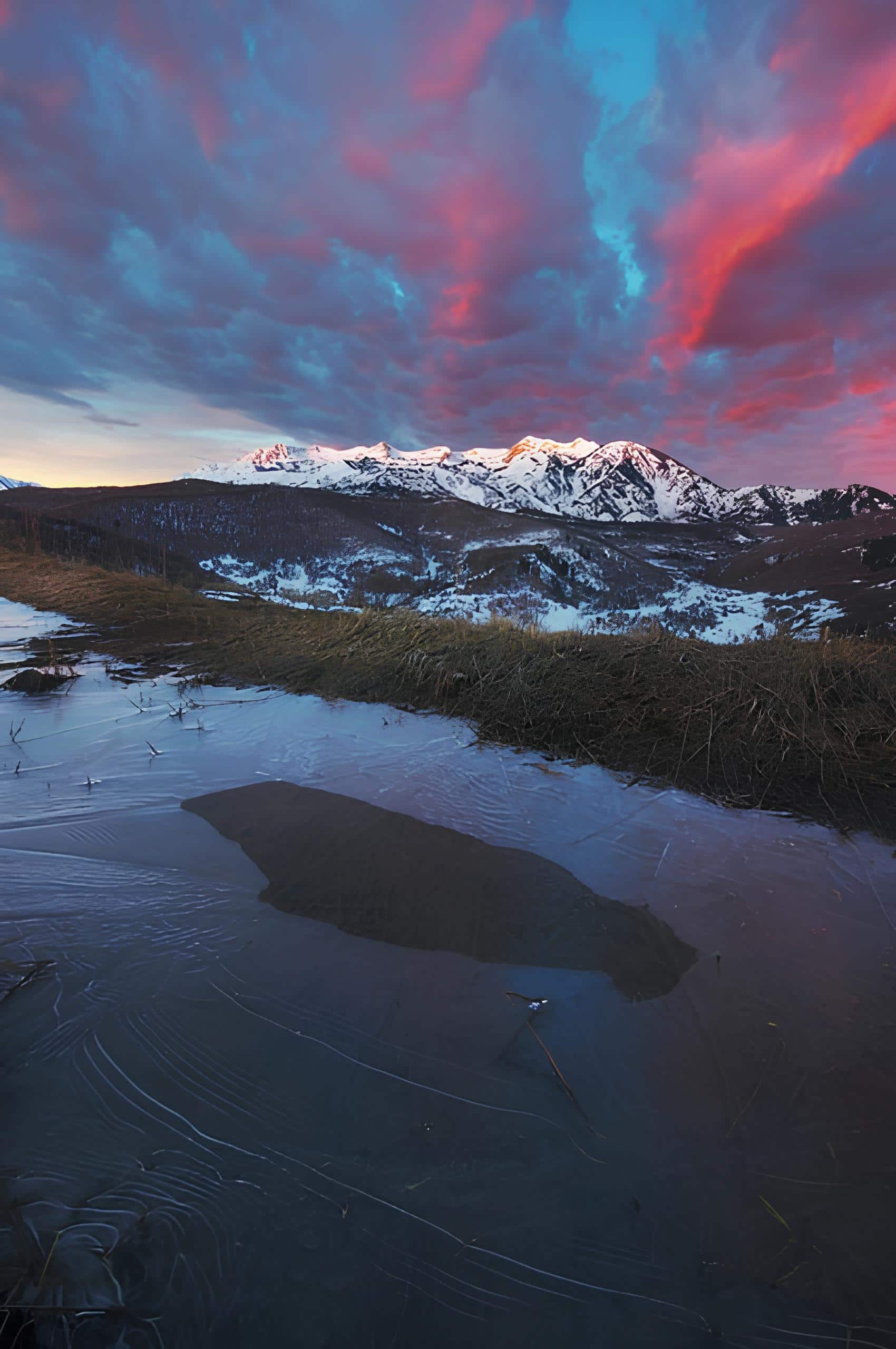 Sunrise Over Snowy Mountain Ridge Snowy mountains glowing under a dramatic sunrise sky