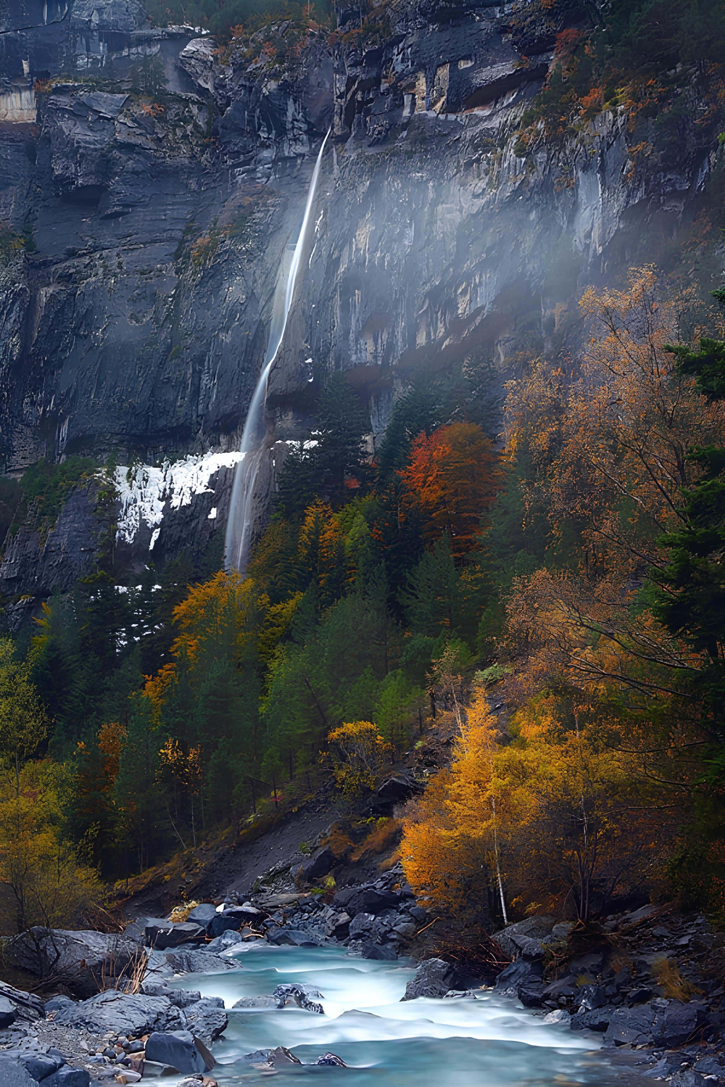Tall Waterfall in Autumn Forest Thin waterfall descending a cliffside amid vibrant fall foliage