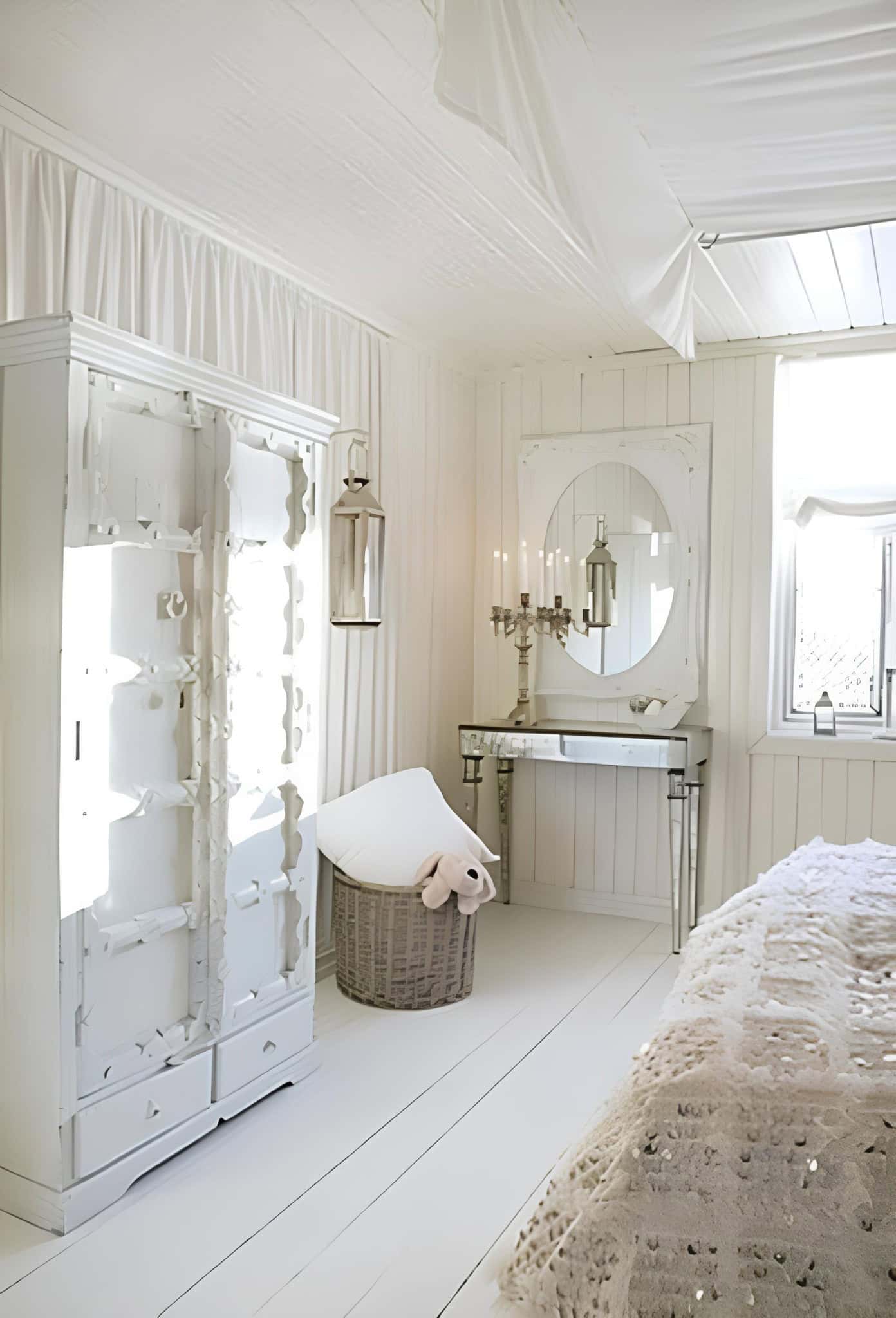 Whimsical White Bedroom with Canopy and Mirrors Whimsical white bedroom with draped ceiling, mirrored vanity and soft lighting