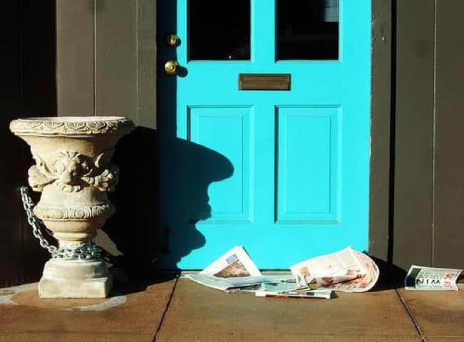 brown front door with textured siding timeless look