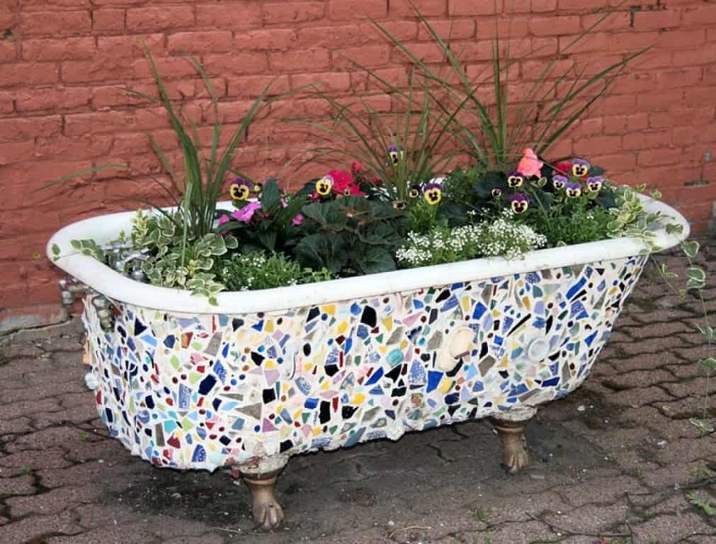 7. Decorate your old bathtub with pieces of tiles and put it in the garden. 7