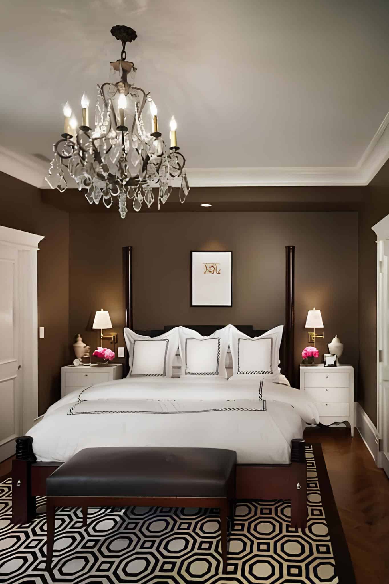 Timeless bedroom with brown walls, crystal chandelier, and white bedding