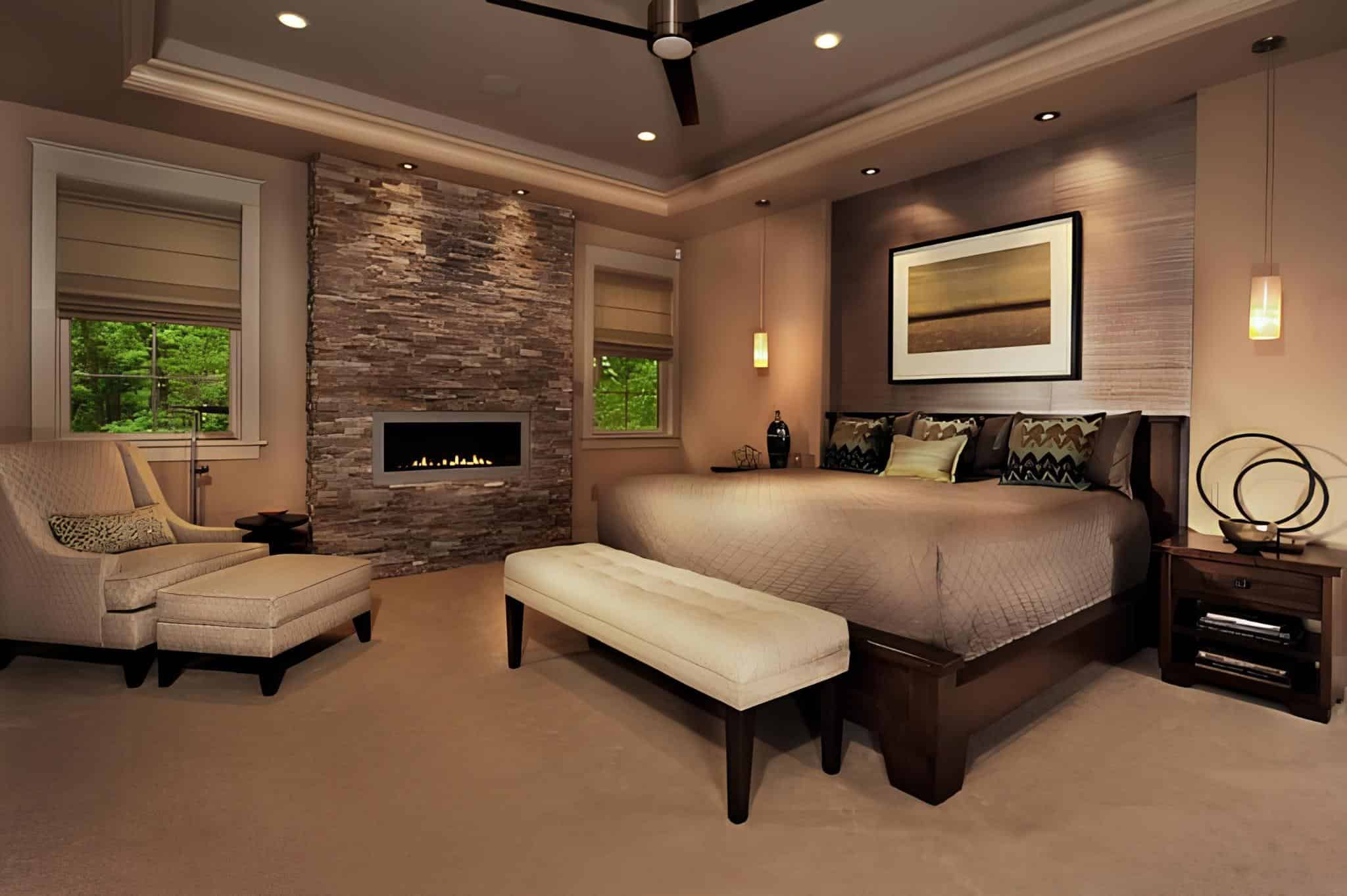 Comfortable bedroom featuring a stone fireplace and relaxing lounge area