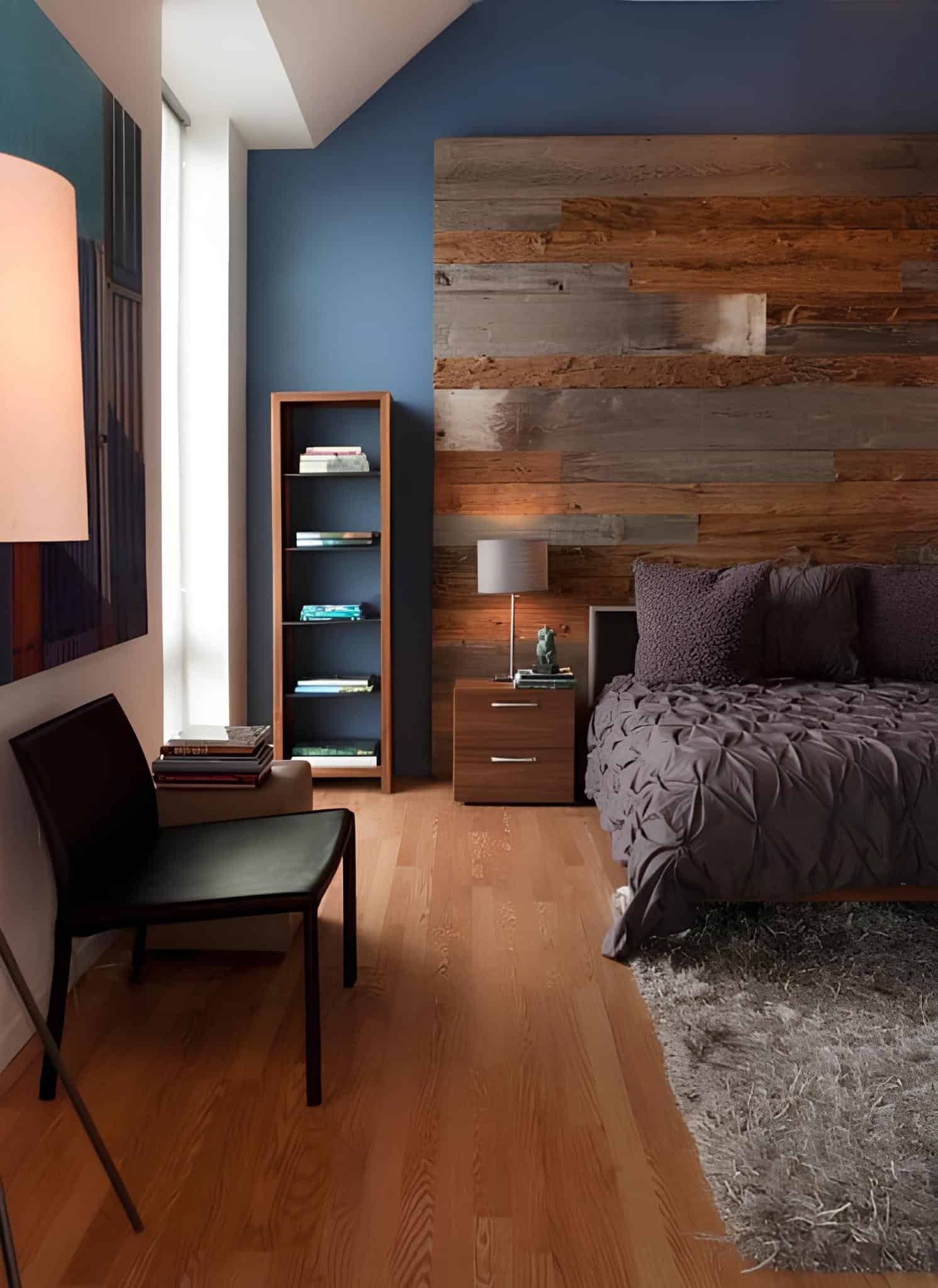 Contemporary bedroom with blue wall, reclaimed wood accent, and cozy bedding