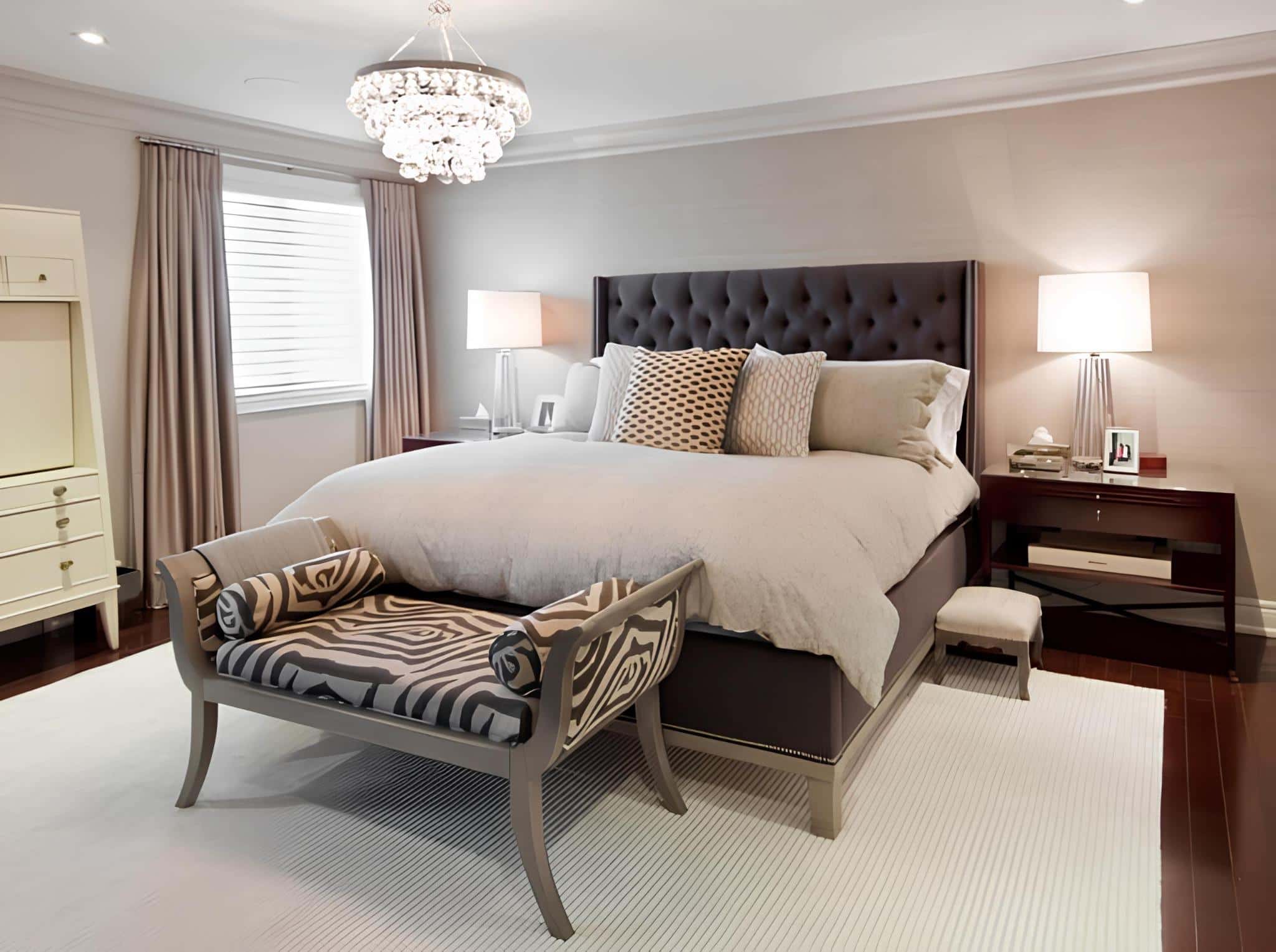 Light-filled bedroom with tufted headboard and crystal chandelier