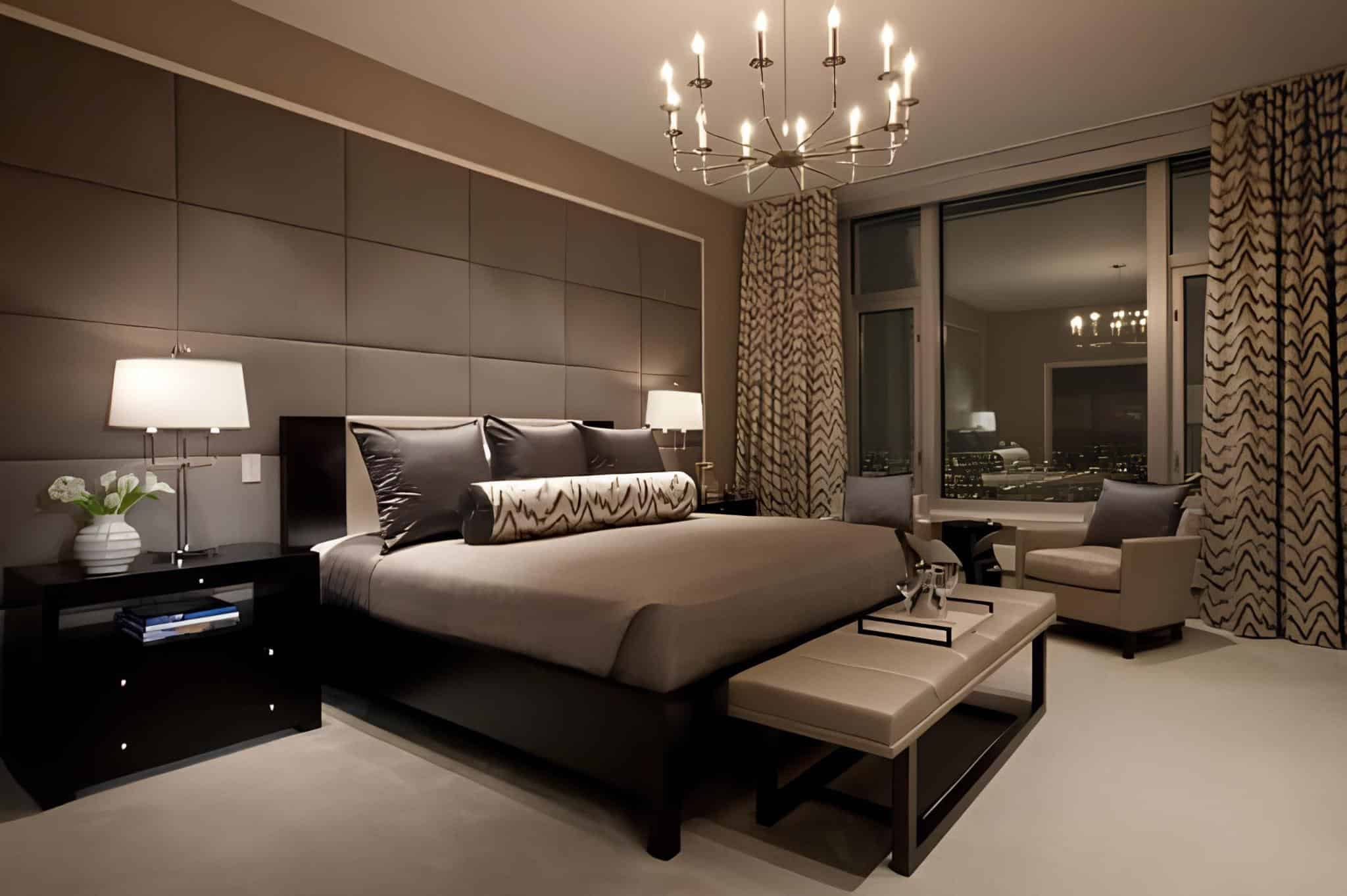 Elegant bedroom featuring an upholstered accent wall and modern chandelier