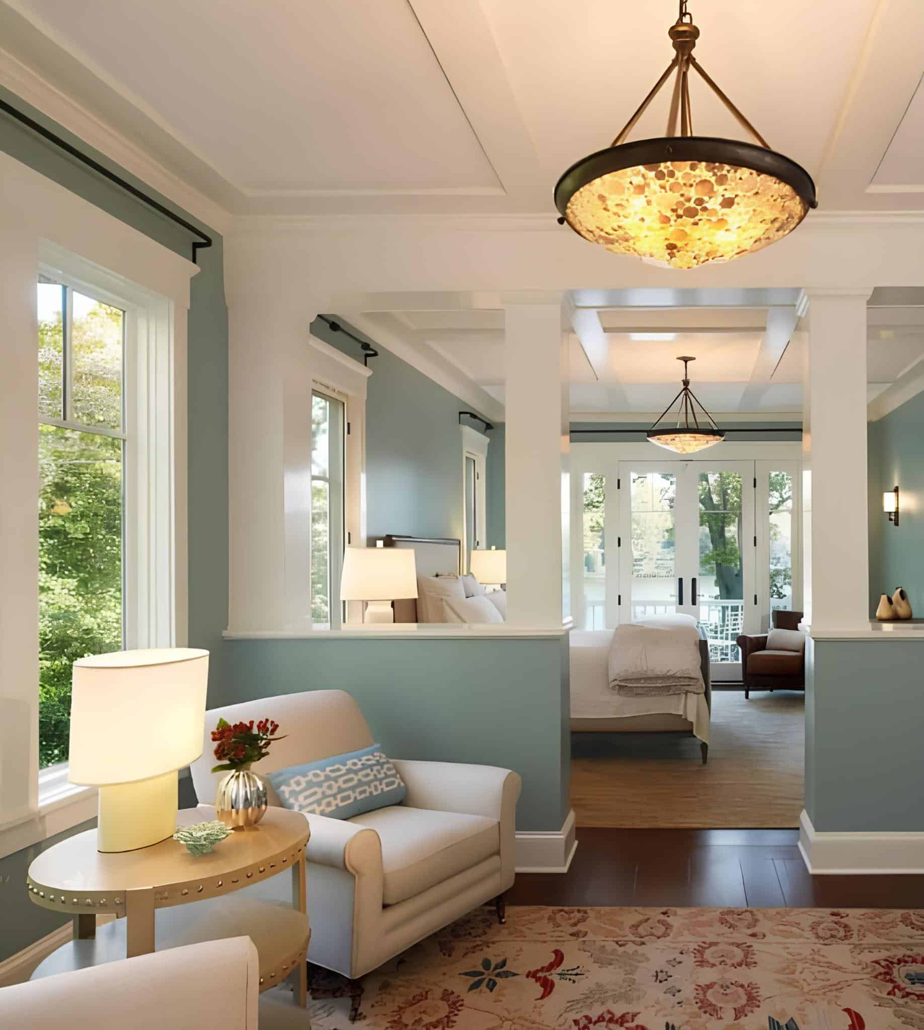 Inviting suite with blue walls, coffered ceiling, and natural light