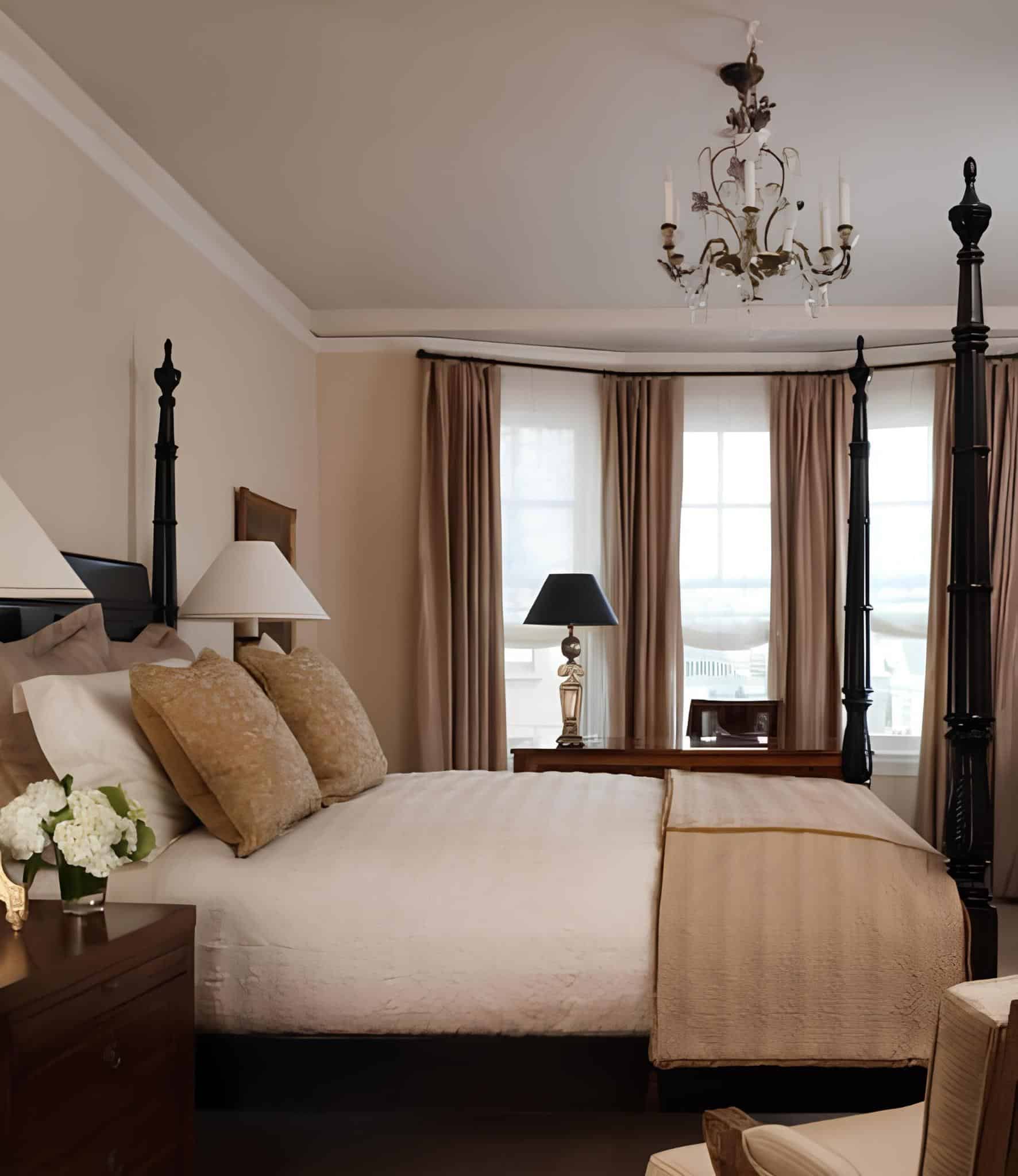 Classic four-poster bed in a warmly lit traditional bedroom