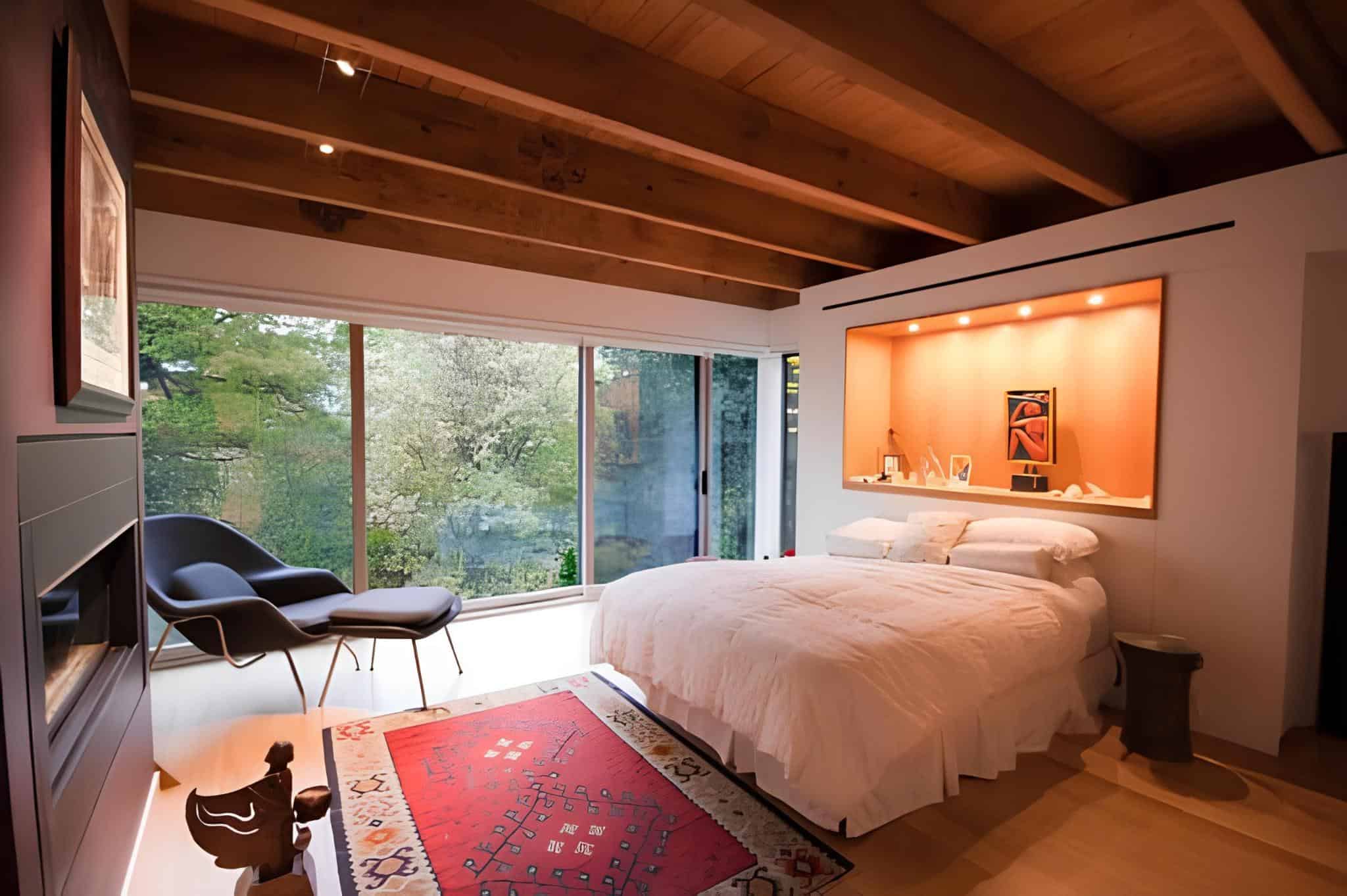 Minimal bedroom with wooden ceiling beams and floor-to-ceiling windows