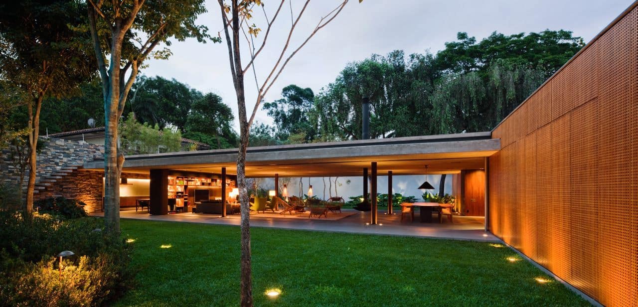 Contemporary outdoor living space with modern architecture, open-air lounge, and lush garden surroundings, emphasizing innovative design and seamless indoor-outdoor integration.