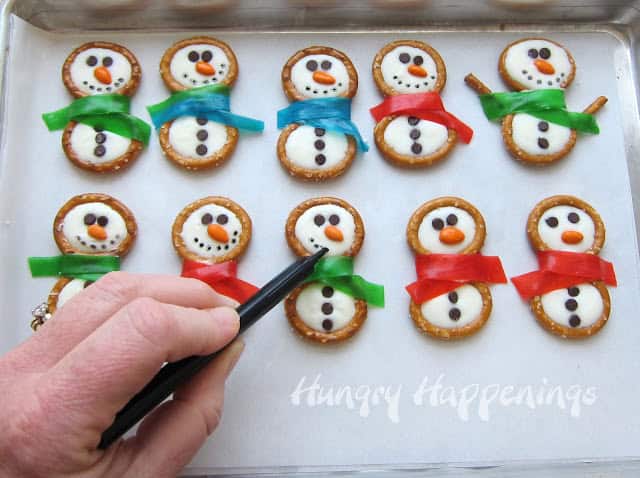 Pretzel rings, Fruit Roll-Ups, and frosting are an easy way to make delicious snowman cookies 10
