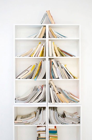 Artfully-arranged books on a shelf can become a Christmas tree as well Source