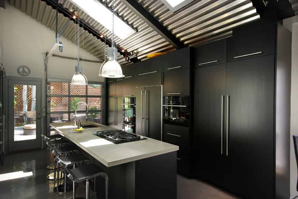 Contemporary black kitchen with concrete counters and stainless steel fixtures Source