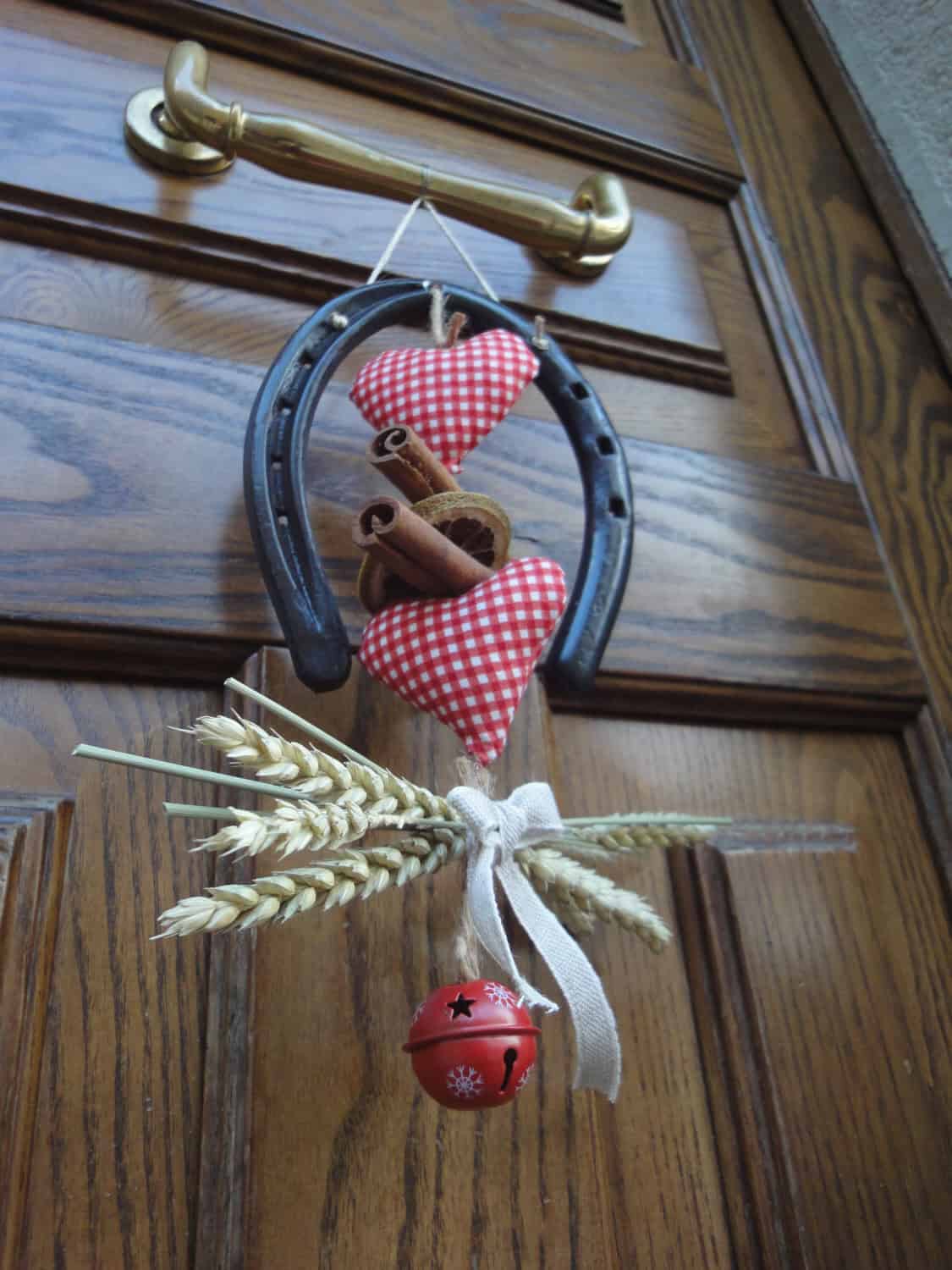 Lucky charm Christmas wreath with horseshoe and bell Source